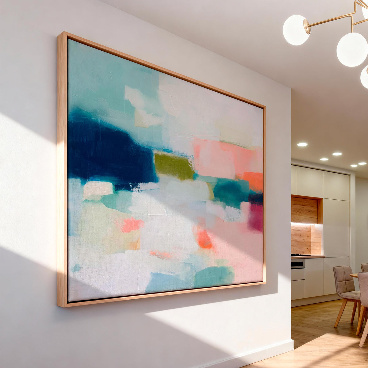 Large horizontal abstract framed canvas wall art featuring deep navy blue, muted aqua, soft blush pink, olive green, coral accents, and layered white brushstrokes, styled above a neutral sofa in a modern coastal living room, offering balanced contrast and refined contemporary color.