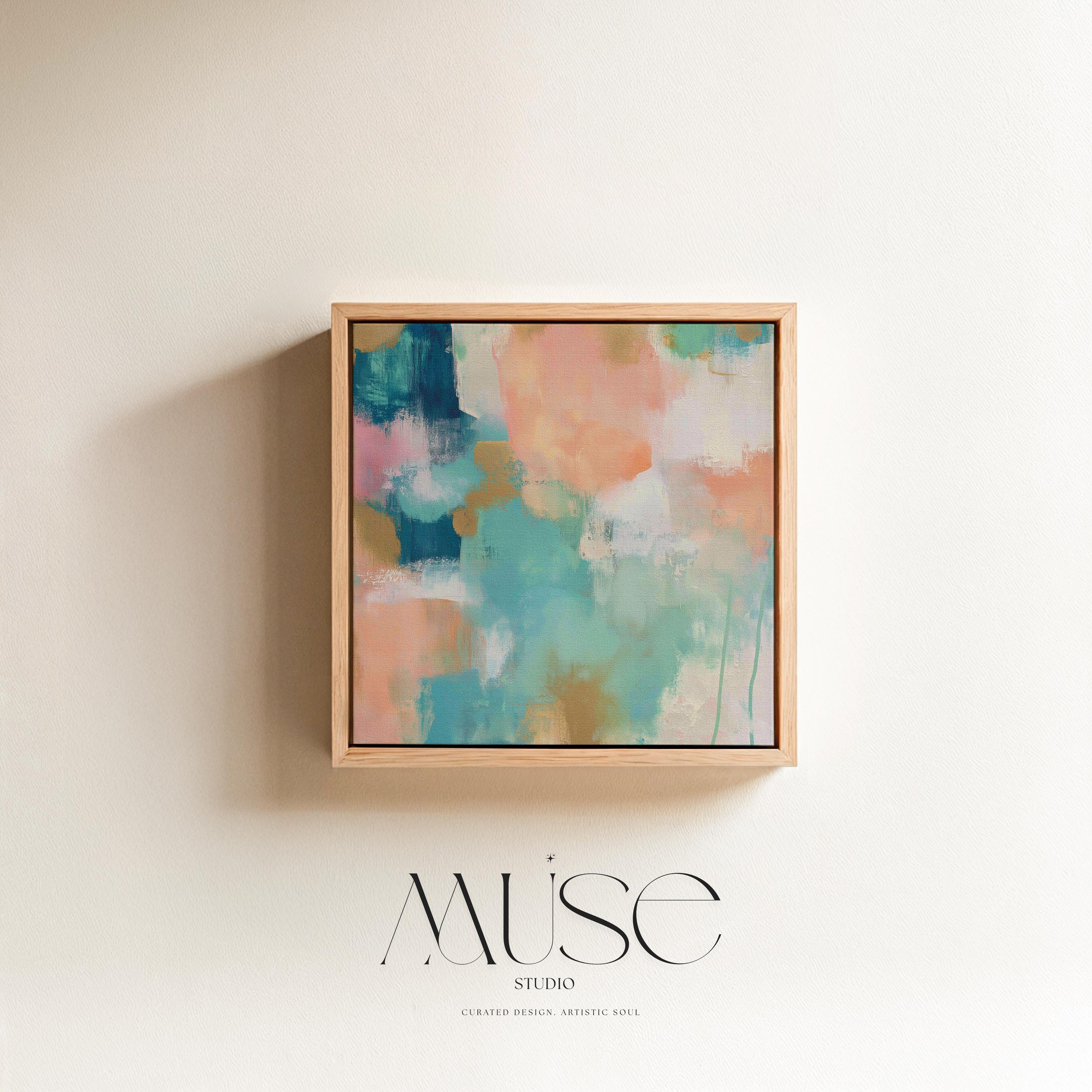 Large square abstract framed canvas wall art featuring coral, peach, teal, aqua blue, and warm sand tones layered over a soft cream background, styled above a neutral sofa, adding soft color contrast and airy painterly texture to a curated living space.