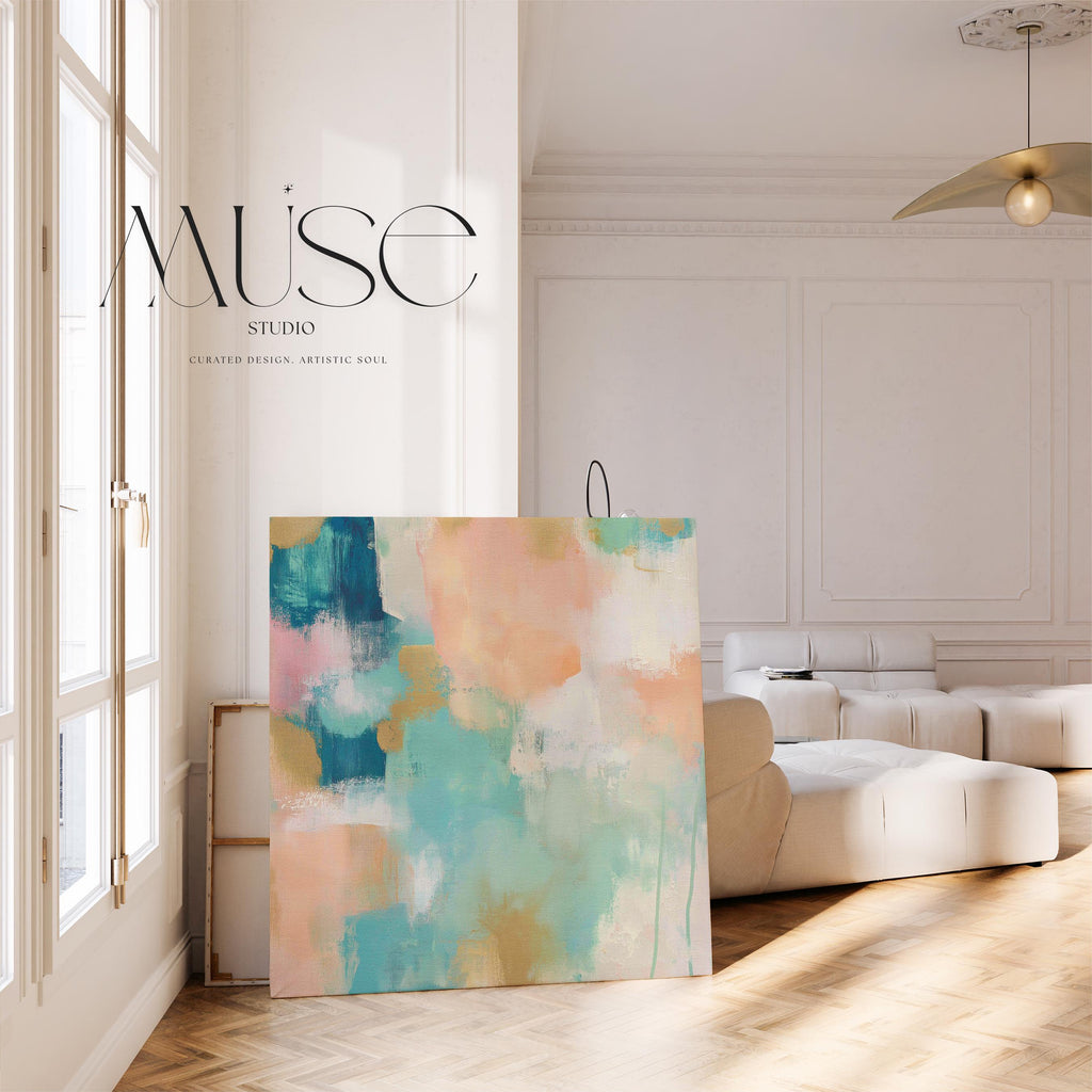 Large square abstract canvas wall art featuring coral, peach, teal, aqua blue, and sand tones with visible brush texture, designed for above couch placement, bringing soft warmth and layered color to a neutral living room or bedroom wall.