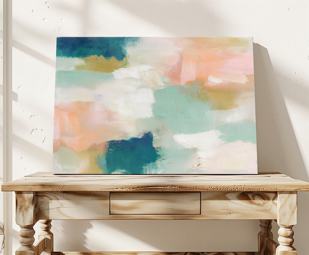 Large horizontal abstract canvas wall art featuring teal blue, mint green, soft peach, and warm sand tones layered over cream, designed for above couch placement, bringing airy color balance and painterly texture to a living room or bedroom wall.