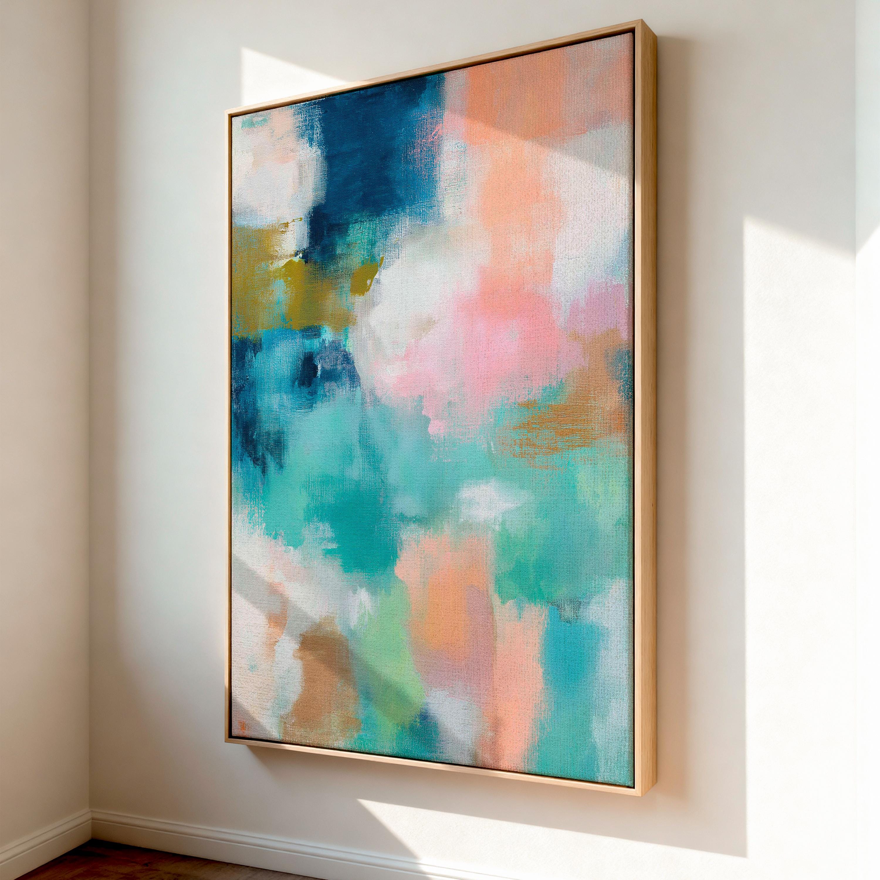 Large vertical abstract framed canvas wall art featuring layered teal, soft peach, cream, blush, and muted gold tones, styled for a serene bedroom or above a console table, offering coastal warmth and quiet luxury in a tall modern interior.