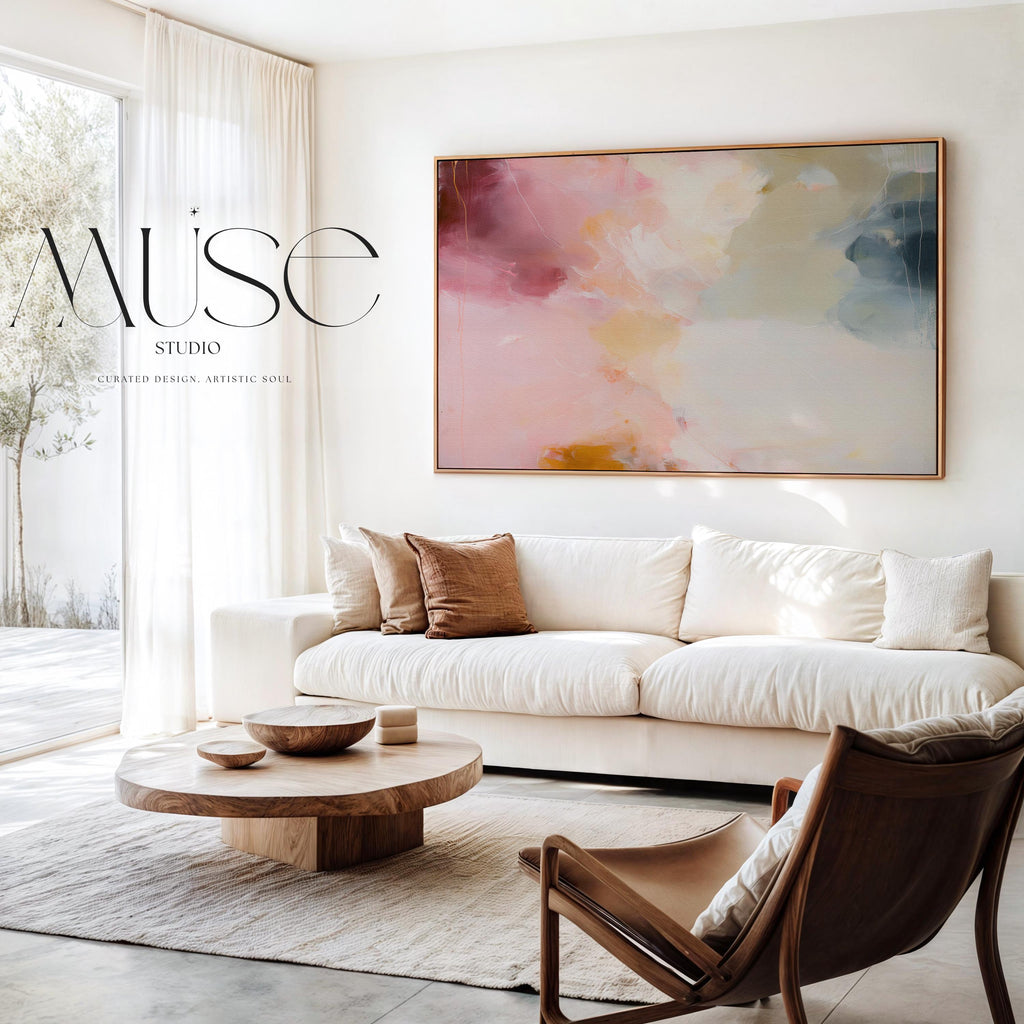 Large horizontal abstract wall art featuring blush pink, coral, cream, and muted blue-grey tones, printed as large canvas wall art and styled above a neutral sofa to create a romantic contemporary focal point in a living room.