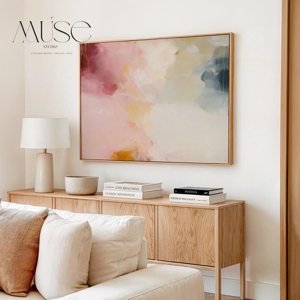 Large horizontal abstract wall art featuring blush pink, coral, cream, and muted blue-grey tones, printed as large canvas wall art and styled above a neutral sofa to create a romantic contemporary focal point in a living room.