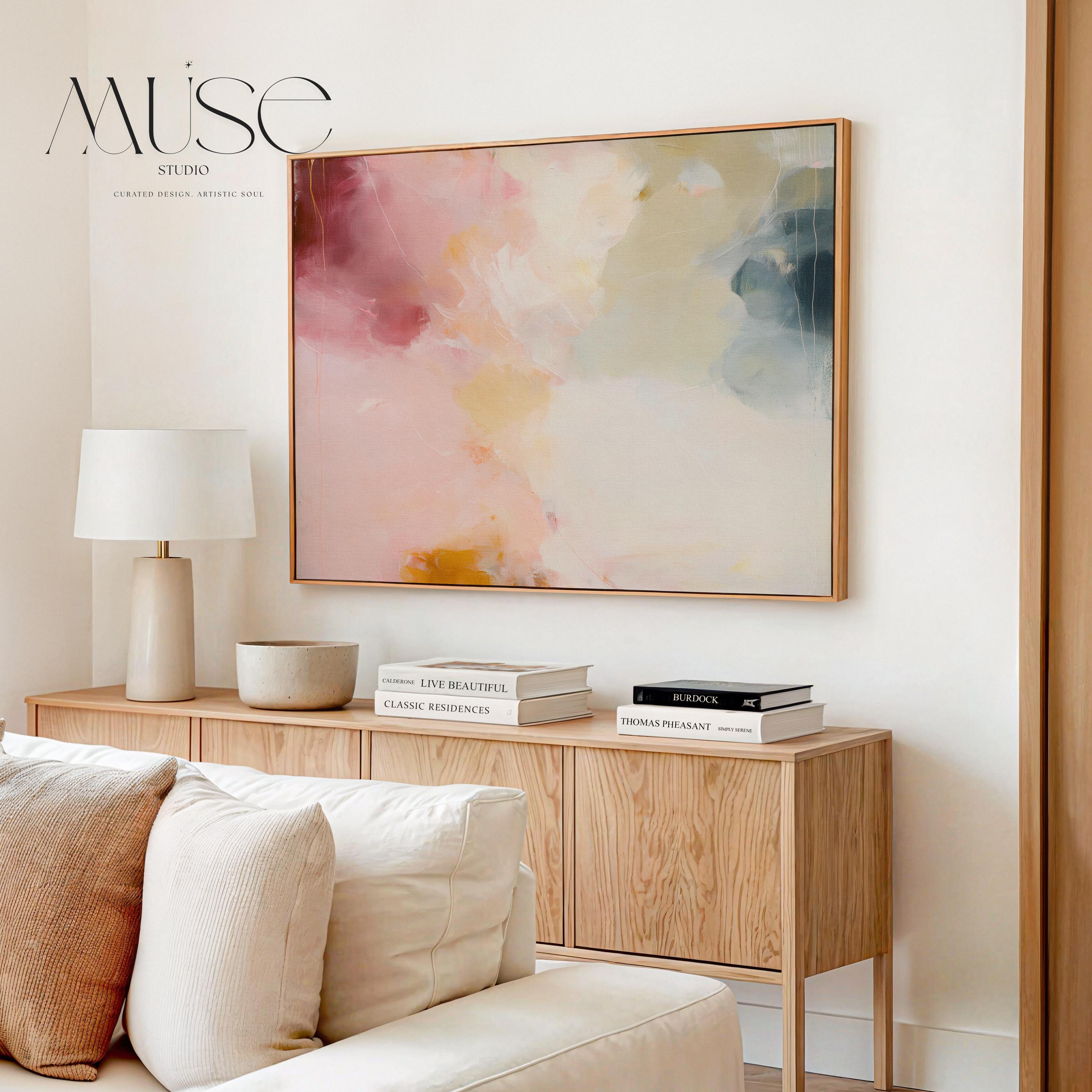 Large horizontal abstract wall art featuring blush pink, coral, cream, and muted blue-grey tones, printed as large canvas wall art and styled above a neutral sofa to create a romantic contemporary focal point in a living room.