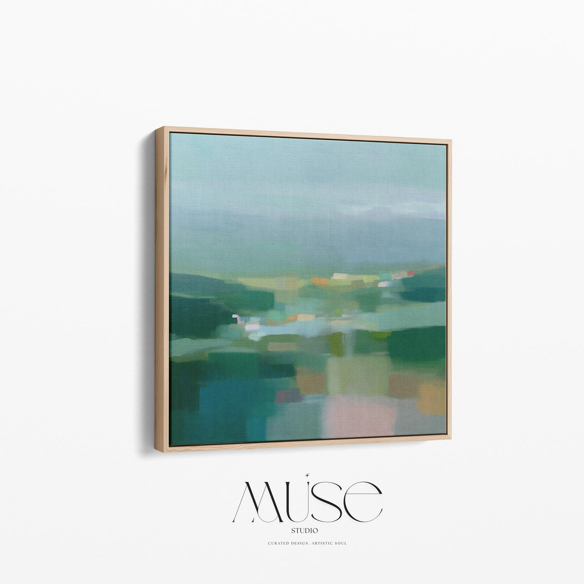 Large square framed canvas wall art in layered sage, deep green, and misty blue tones styled against a light neutral wall, creating a calm nature-inspired focal point in a refined interior.