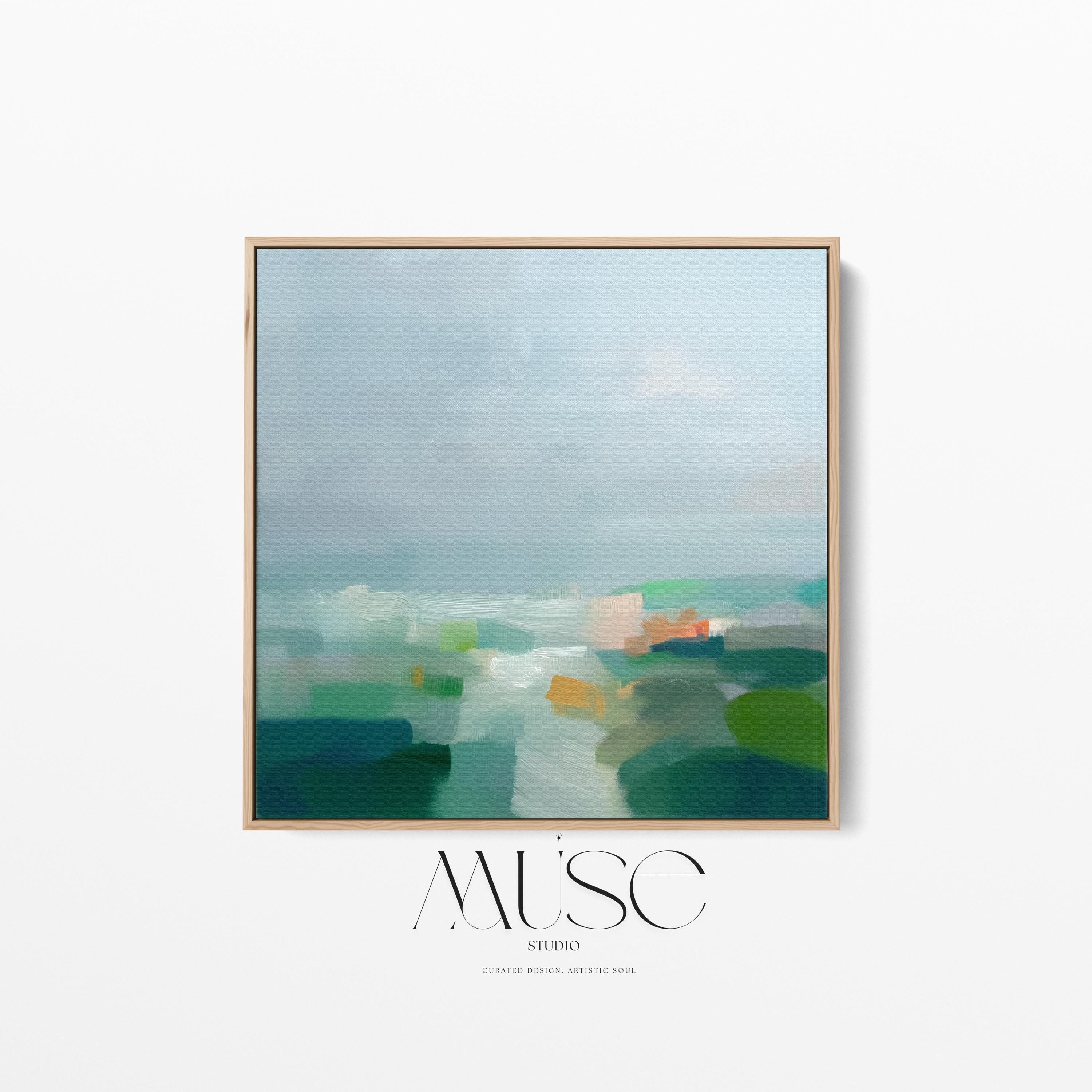Large square framed canvas wall art in sage green, soft blue, and muted cream tones styled in a warm neutral farmhouse interior, creating a calm countryside-inspired focal point with soft horizon depth.
