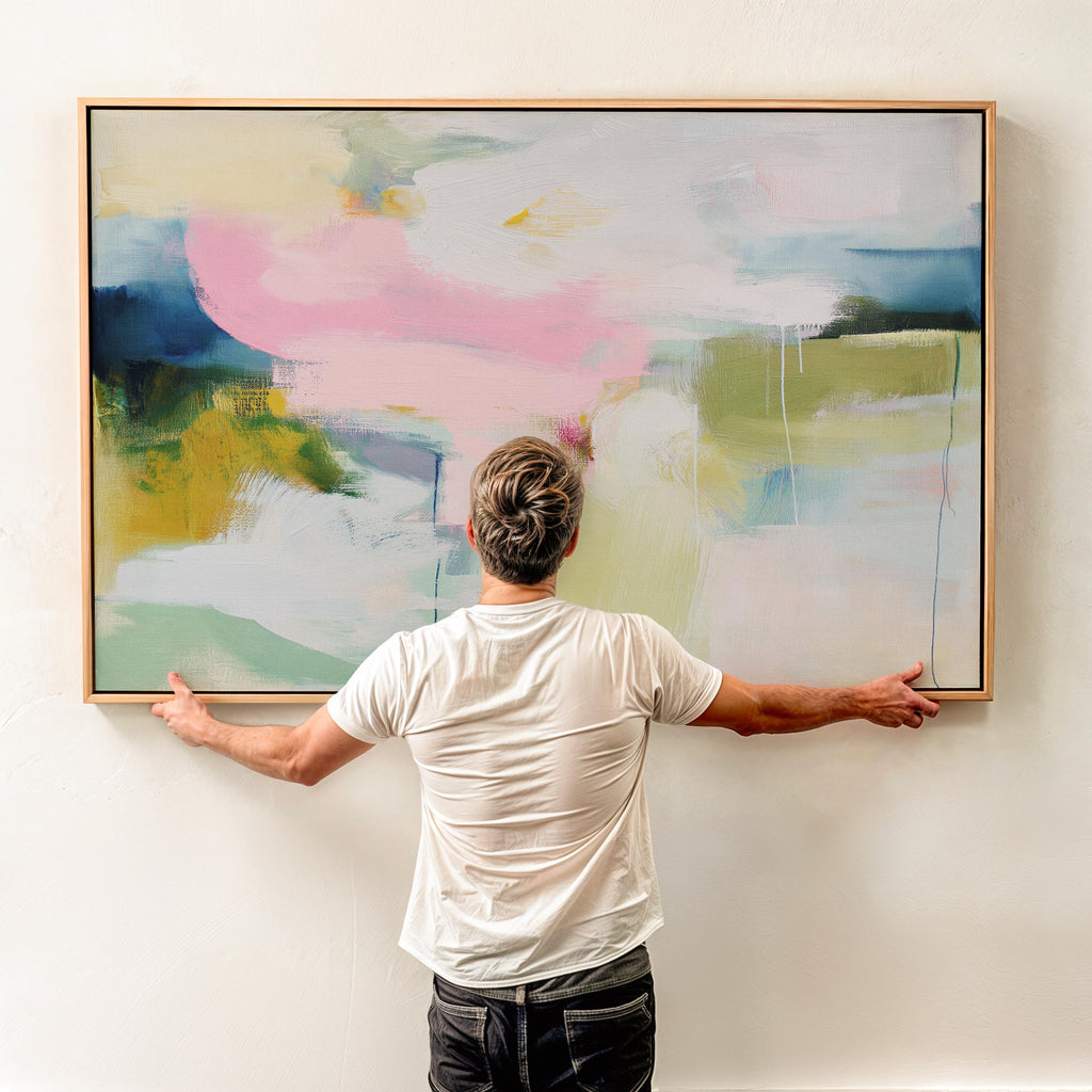 Muse Studio large framed canvas wall art featuring a soft pastel abstract composition in blush pink, olive, mint, mustard, and sky tones, printed with museum-grade giclée inks on premium artist canvas for living room decor.