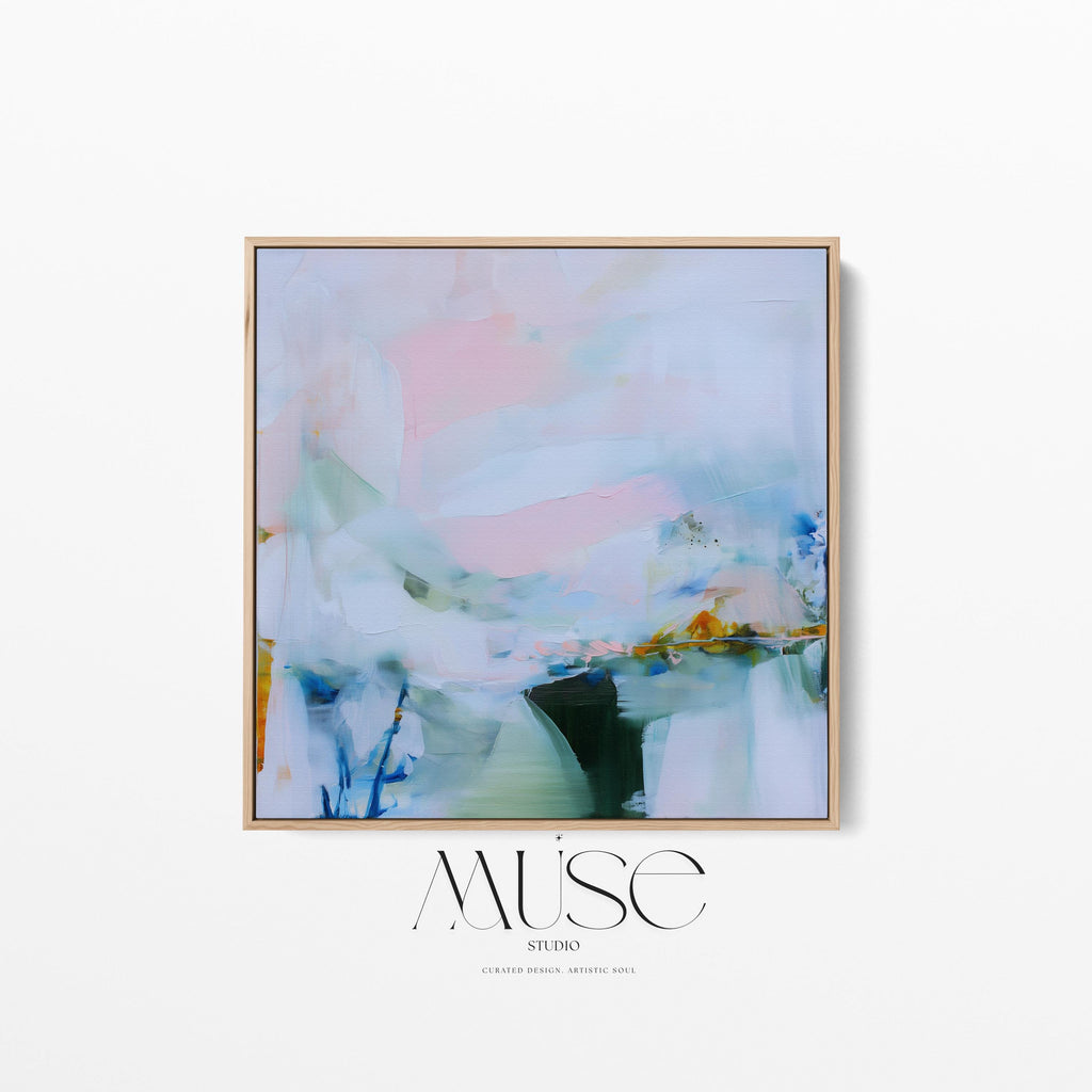 Muse Studio framed abstract wall art in soft blush, misted blue, pale sage, and deep teal with warm ochre accents, printed with museum-grade giclée inks on premium gallery-wrapped canvas, set in a natural wood float frame, styled above a neutral linen sofa in an organic transitional living room with warm oak tones and layered textures.