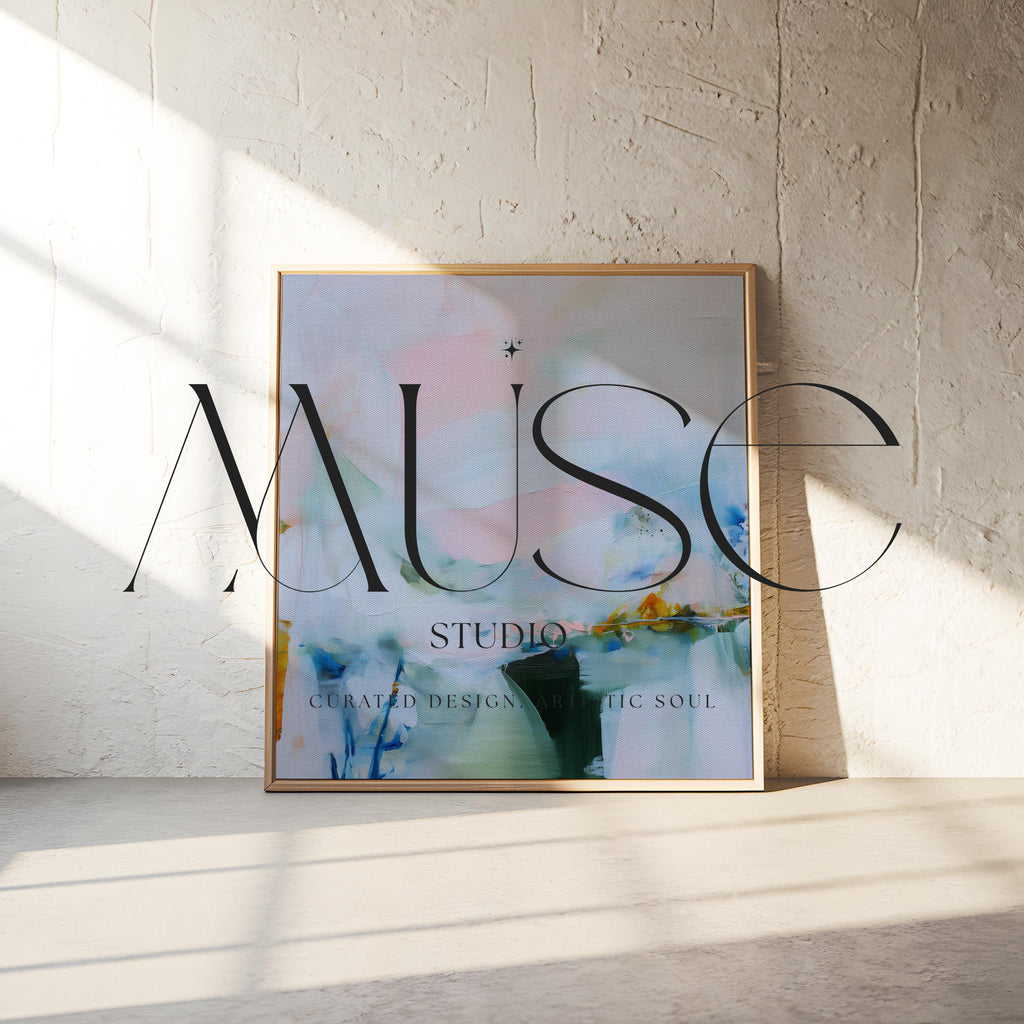 Muse Studio framed abstract wall art in soft blush, misted blue, pale sage, and deep teal with warm ochre accents, printed with museum-grade giclée inks on premium gallery-wrapped canvas, set in a natural wood float frame, styled above a neutral linen sofa in an organic transitional living room with warm oak tones and layered textures.