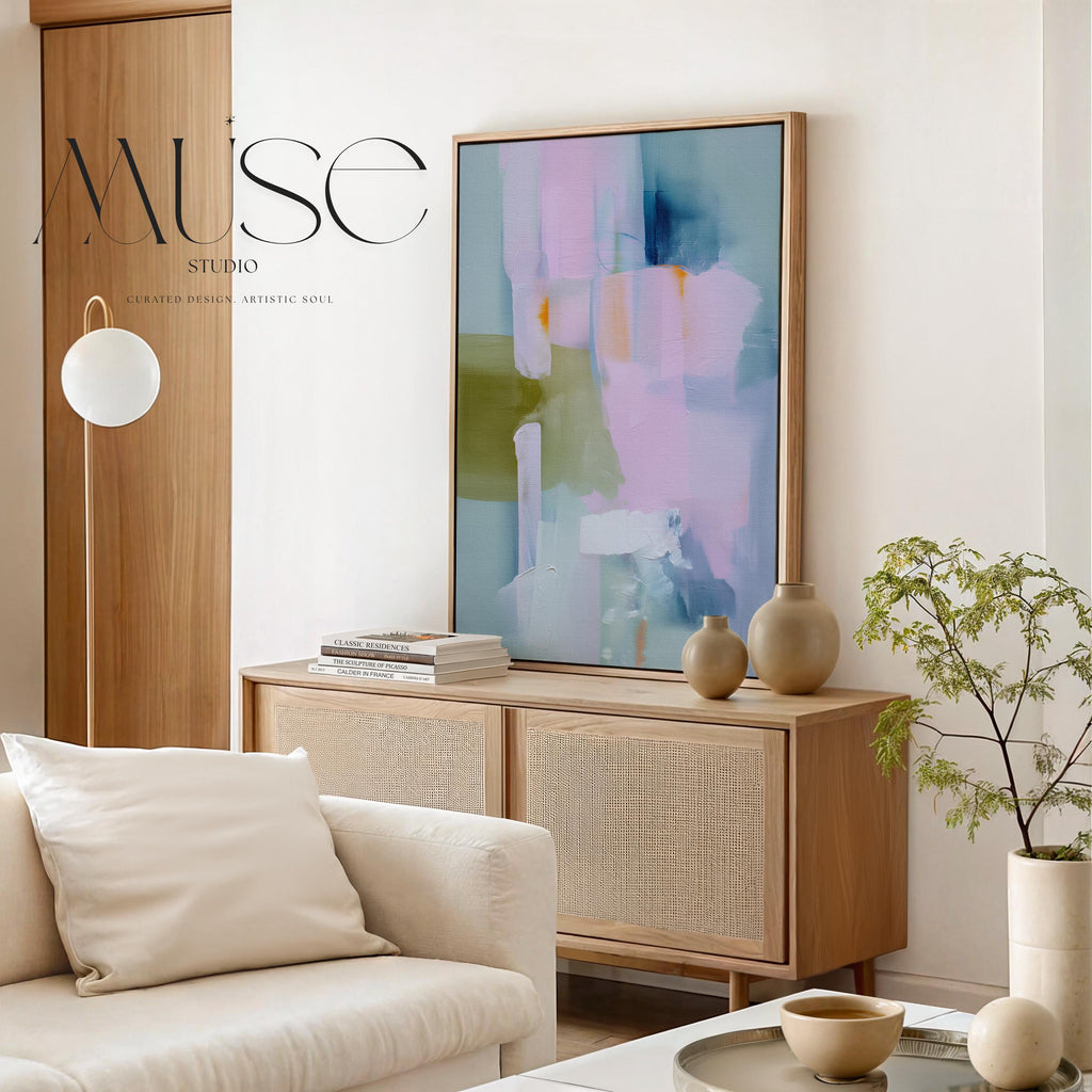 Muse Studio framed abstract wall art titled Soft Sonata 1043 in blush, sage, lilac, and misted blue, printed with museum-grade giclée inks on premium gallery-wrapped canvas in a natural wood float frame, styled vertically in a serene organic transitional bedroom and spa-inspired bathroom with warm oak and soft neutral textiles.