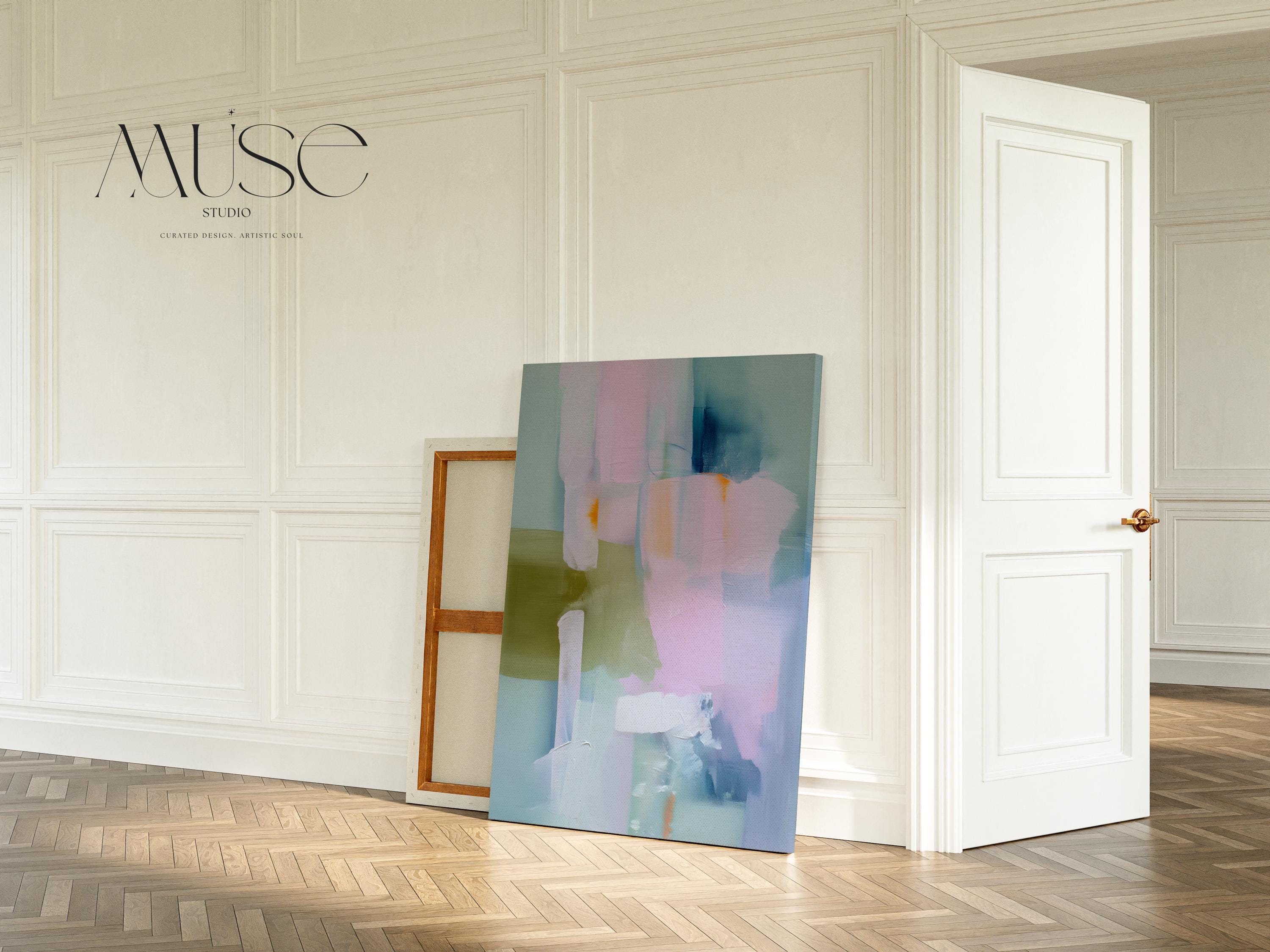 Muse Studio large vertical abstract canvas wall art printed with museum-grade giclée inks on premium gallery-wrapped canvas, featuring blush and sage pastel tones in an Organic Transitional style, styled above a bed in a serene coastal bedroom.