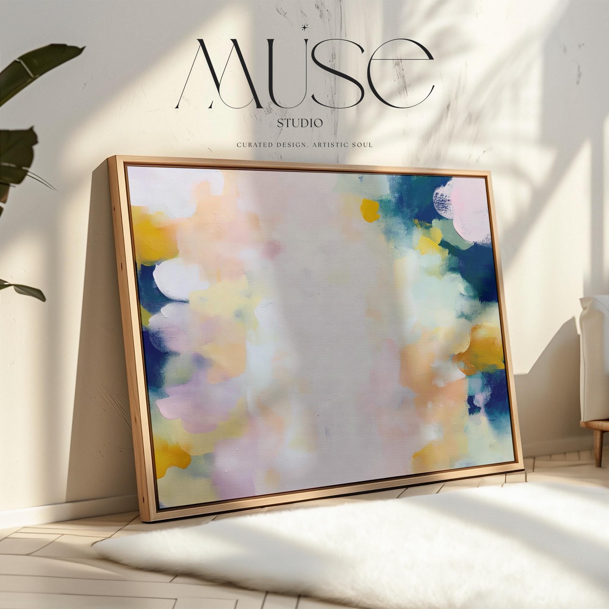Muse Studio large horizontal framed abstract wall art printed with museum-grade giclée inks on premium gallery-wrapped canvas, featuring blush and navy pastel tones in an Organic Transitional style, styled above a linen sofa in a coastal living room.