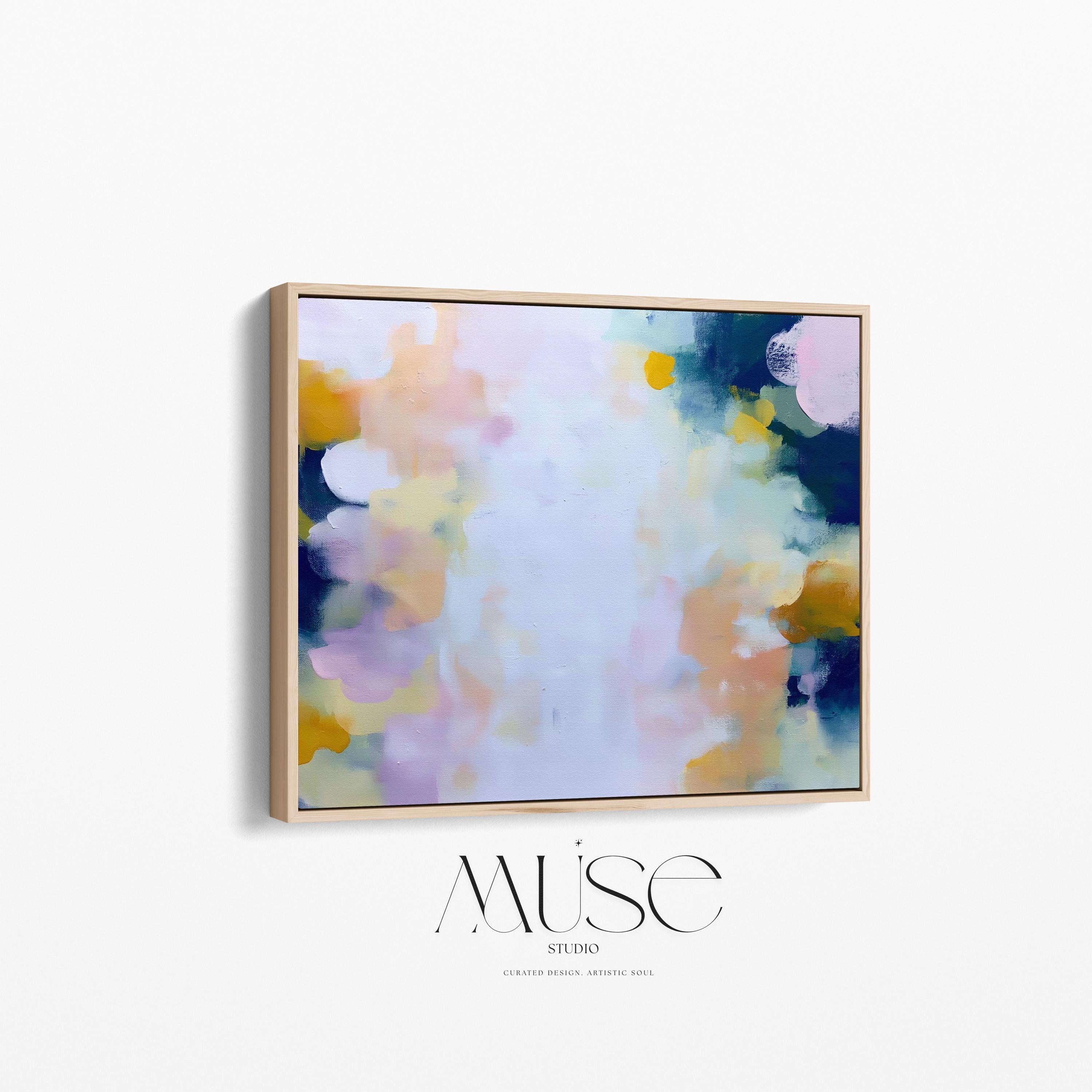 Muse Studio large horizontal framed abstract wall art printed with museum-grade giclée inks on premium gallery-wrapped canvas, featuring blush and navy pastel tones in an Organic Transitional style, styled above a linen sofa in a coastal living room.