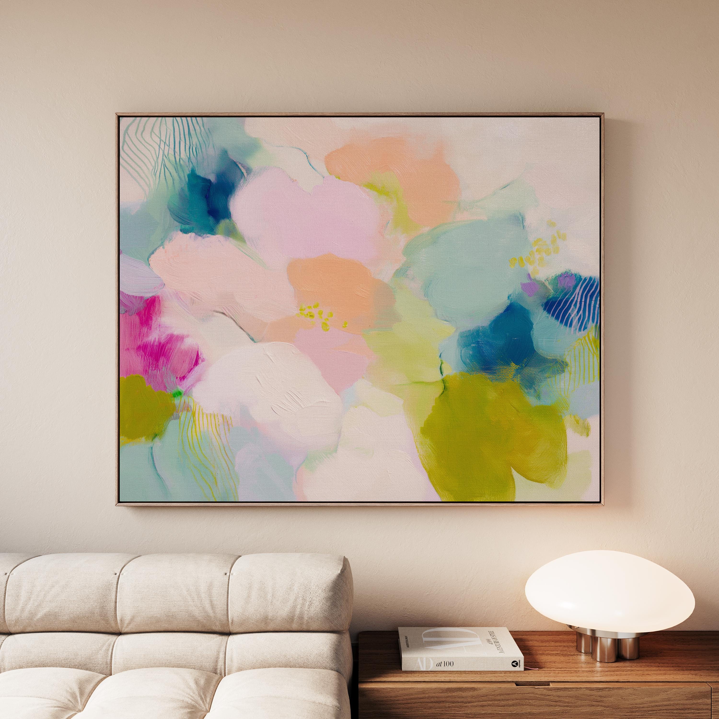 Muse Studio large framed abstract wall art on museum-grade artist canvas with fade-resistant giclée inks, framed in 100% solid wood with custom framing options in gold, silver, natural oak, black, and white, styled above a wood desk in a modern Soft Contemporary Pastel home office.