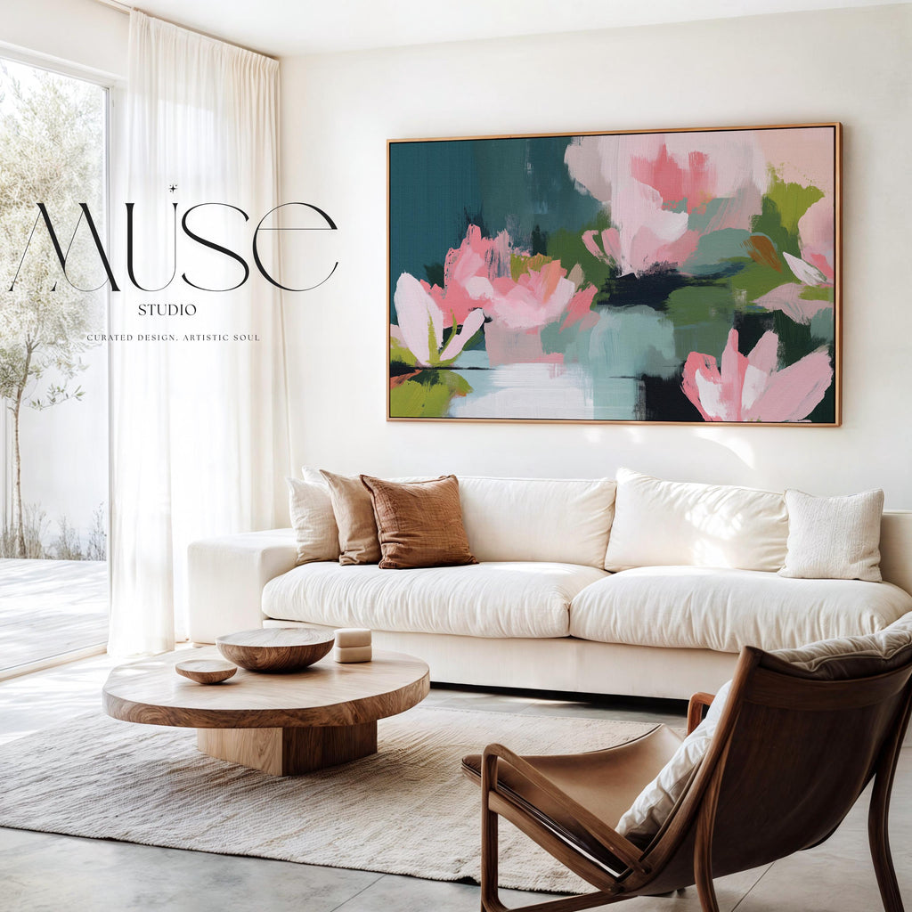 Muse Studio large horizontal floral abstract wall art in spring green, blush pink, and deep teal on museum-grade gallery-wrapped artist canvas, framed in solid wood, styled above a linen sofa in an Organic Transitional living room with Romantic Botanical influence.