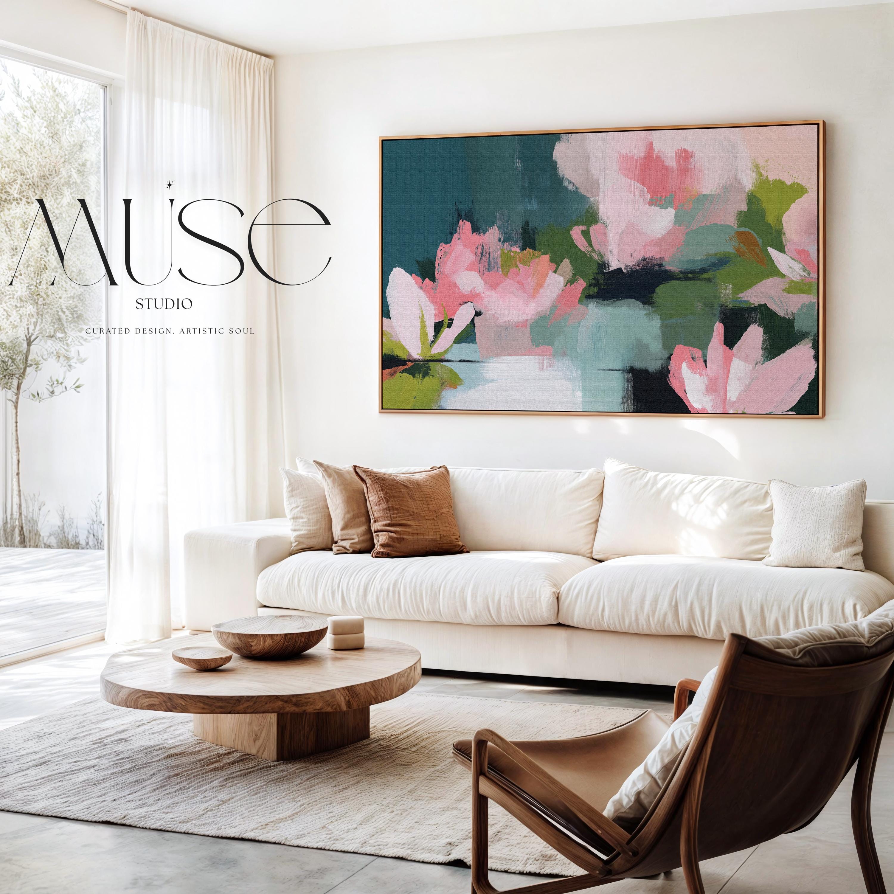 Muse Studio large horizontal floral abstract wall art in spring green, blush pink, and deep teal on museum-grade gallery-wrapped artist canvas, framed in solid wood, styled above a linen sofa in an Organic Transitional living room with Romantic Botanical influence.