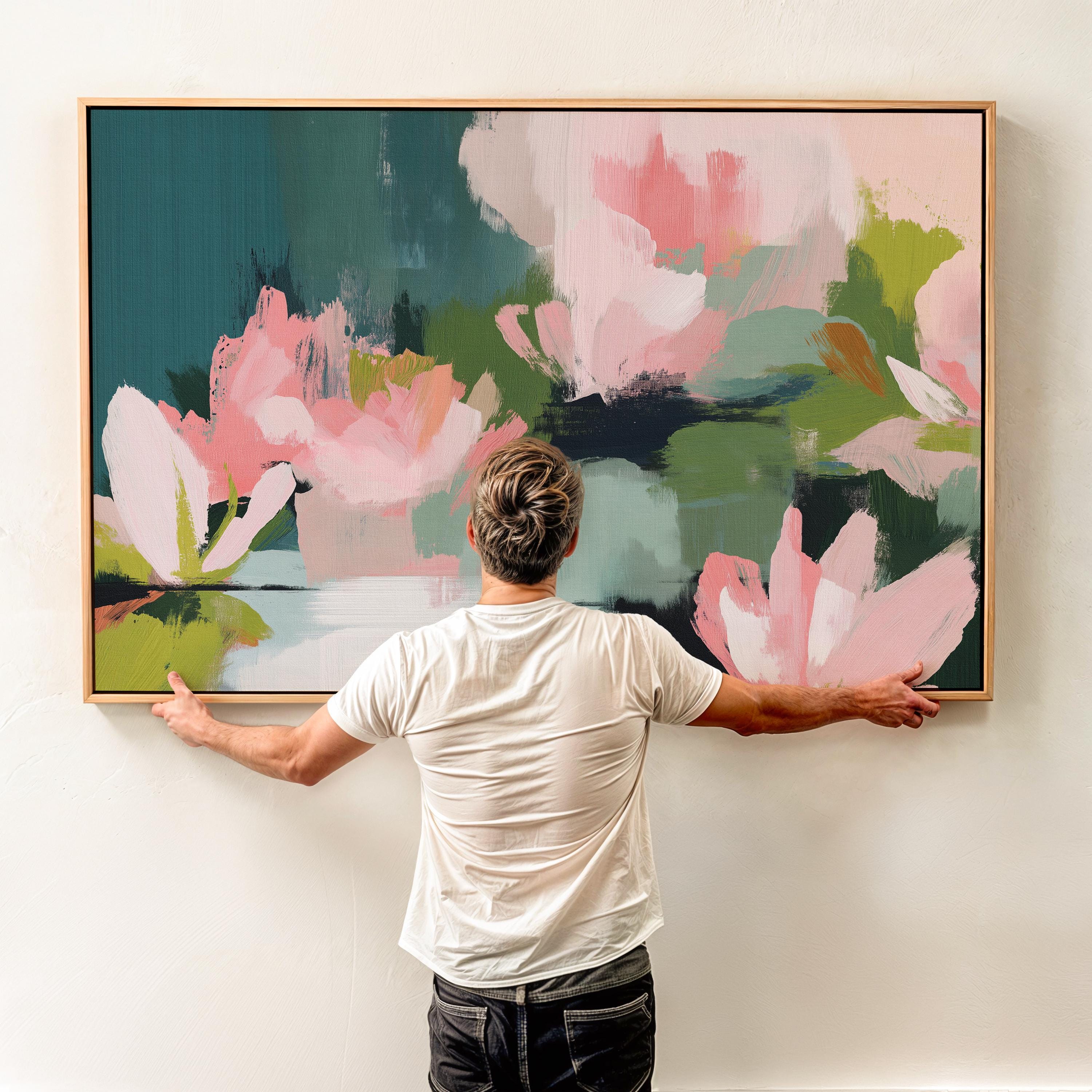 Muse Studio large horizontal floral abstract wall art in spring green, blush pink, and deep teal on museum-grade gallery-wrapped artist canvas, framed in solid wood, styled above a linen sofa in an Organic Transitional living room with Romantic Botanical influence.