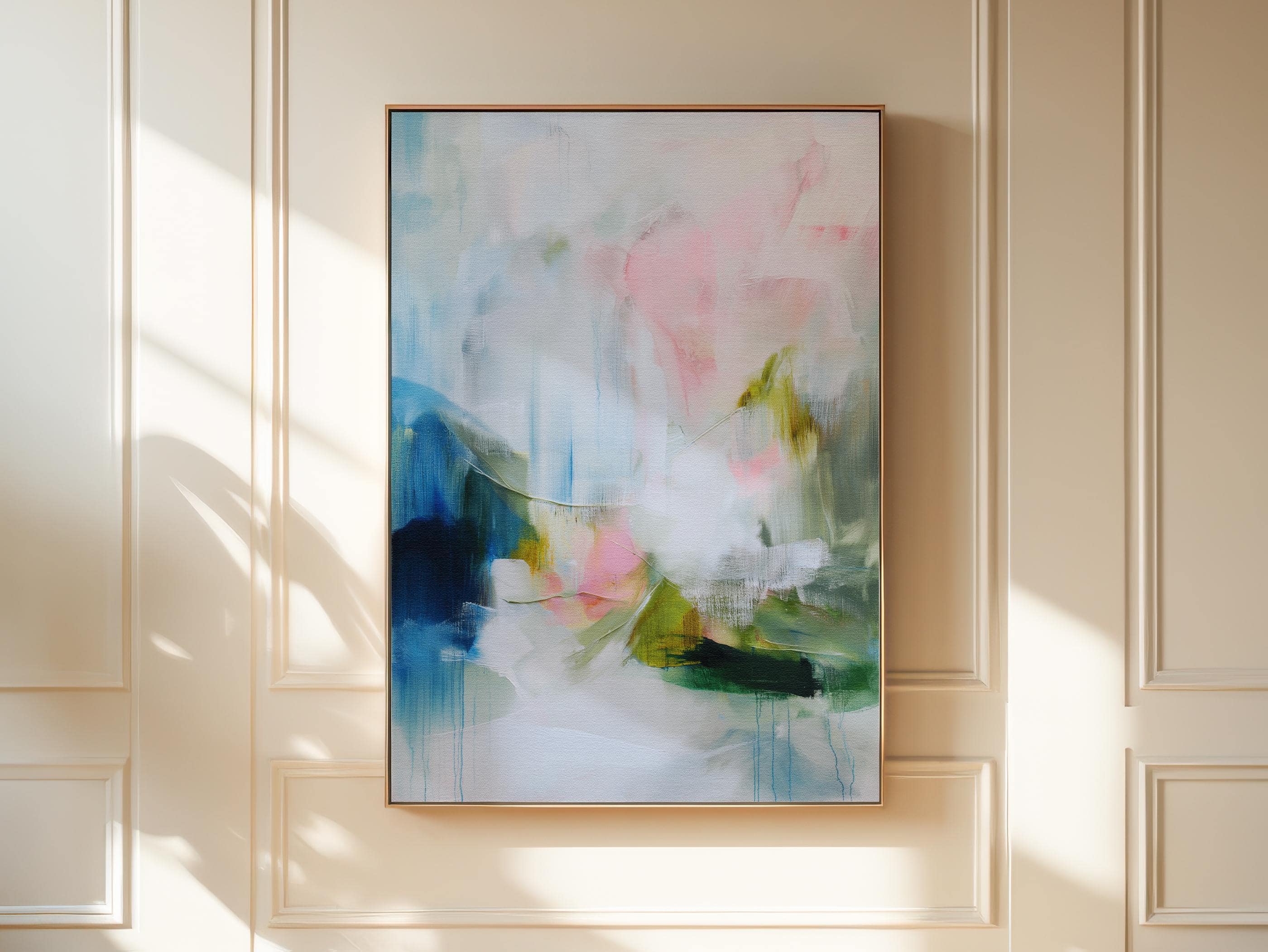 Spring Showers No. 1061 by Muse Studio & Co. vertical abstract wall art in blue, blush pink, and green tones, printed with museum-grade giclée inks on premium gallery-wrapped canvas and framed in natural wood float frame, styled in a serene bedroom above bed in soft contemporary interior.