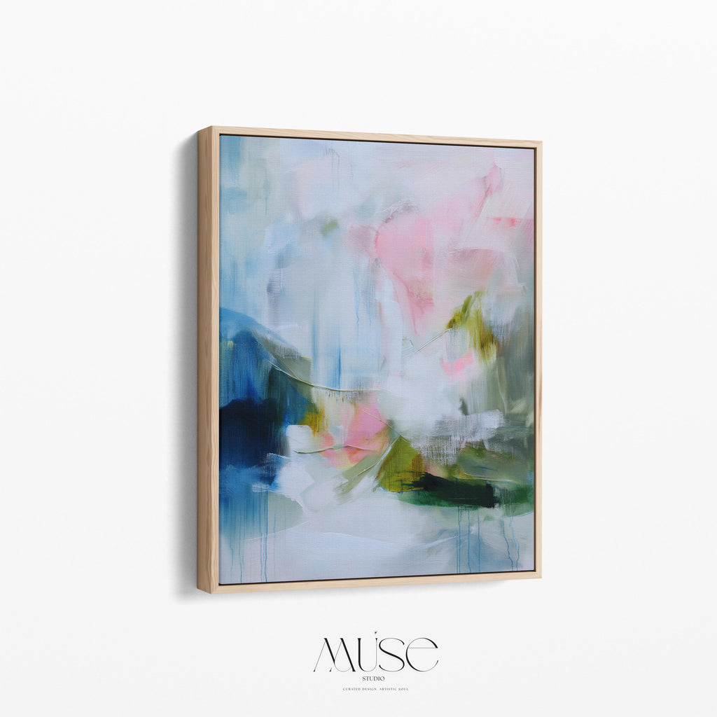 Spring Showers No. 1061 by Muse Studio & Co. vertical abstract wall art in blue, blush pink, and green tones, printed with museum-grade giclée inks on premium gallery-wrapped canvas and framed in natural wood float frame, styled in a serene bedroom above bed in soft contemporary interior.