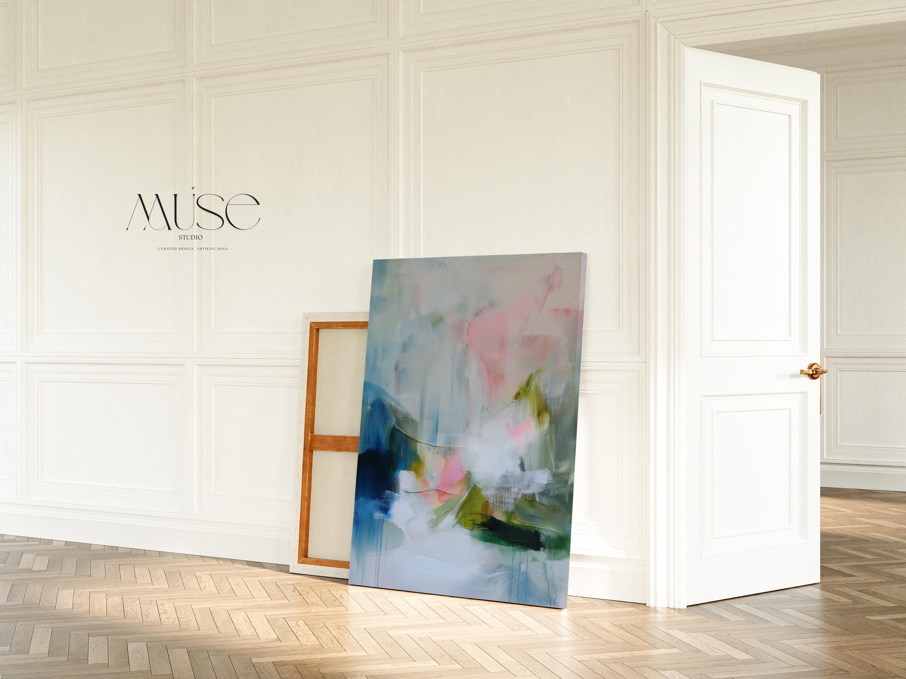 Spring Showers No. 1061 by Muse Studio & Co. vertical abstract canvas wall art in blue, blush pink, and soft green tones with a cottage botanical style, printed with museum-grade giclée inks on premium gallery-wrapped canvas, styled above a linen bed in a romantic cottage bedroom with soft contemporary decor.