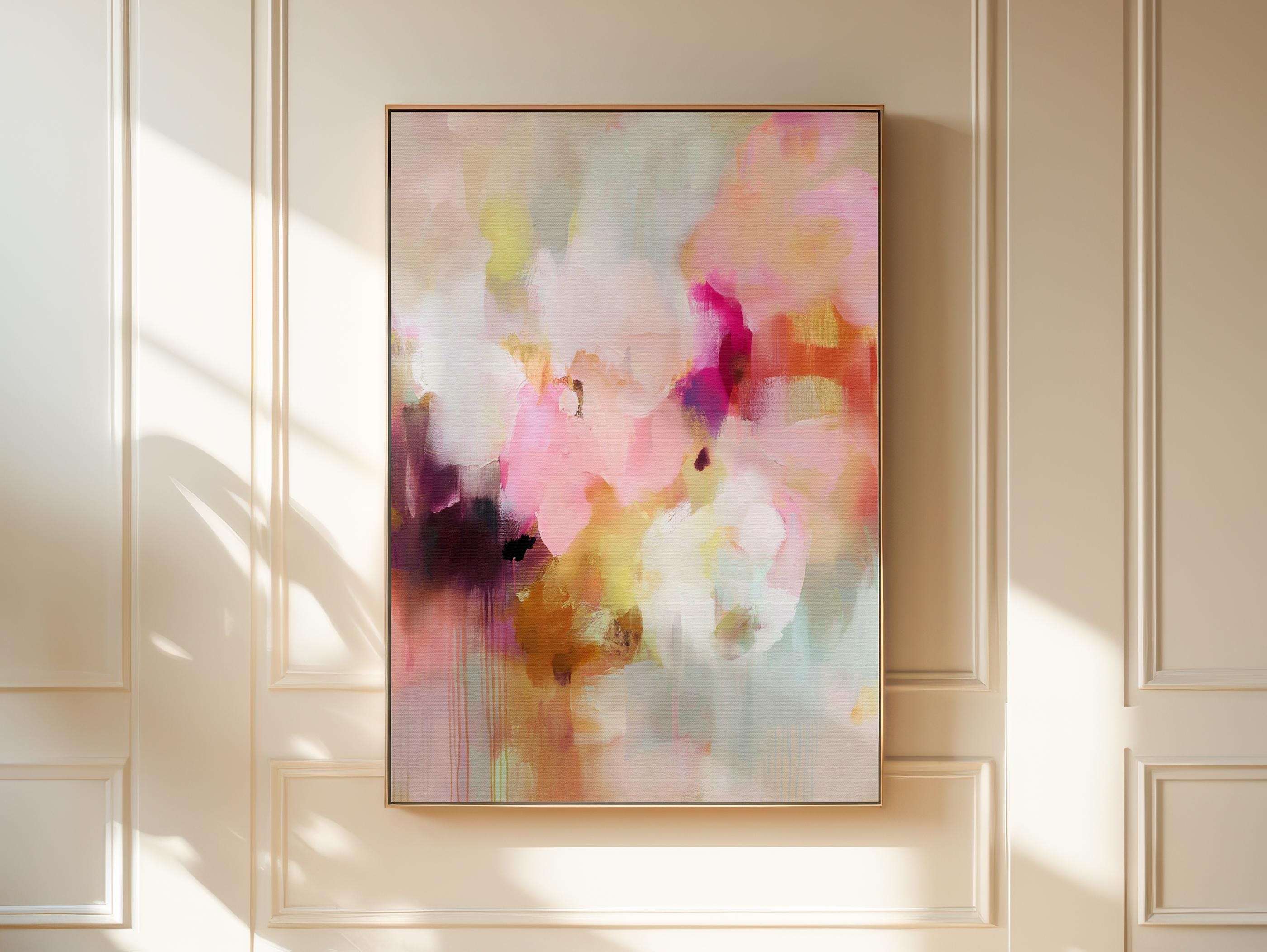 Spring Showers No. 1061 by Muse Studio & Co. vertical framed abstract wall art in blush pink, coral, ochre, and soft aqua tones, printed with museum-grade giclée inks on premium canvas and finished in a natural wood float frame, styled in a boho living room with warm neutral textures and layered decor.