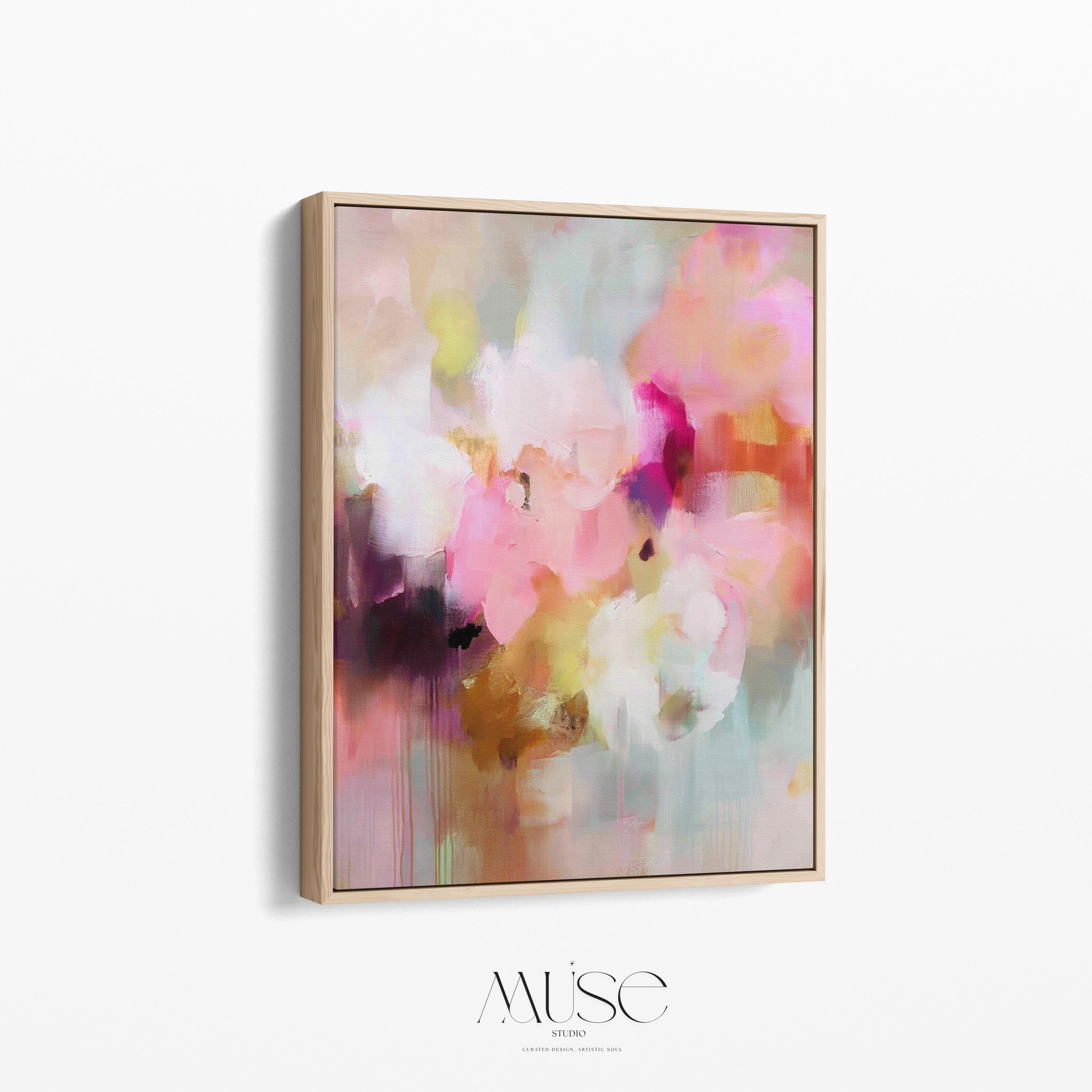 Spring Showers No. 1061 by Muse Studio & Co. vertical framed abstract wall art in blush pink, coral, ochre, and soft aqua tones, printed with museum-grade giclée inks on premium canvas and finished in a natural wood float frame, styled in a boho living room with warm neutral textures and layered decor.
