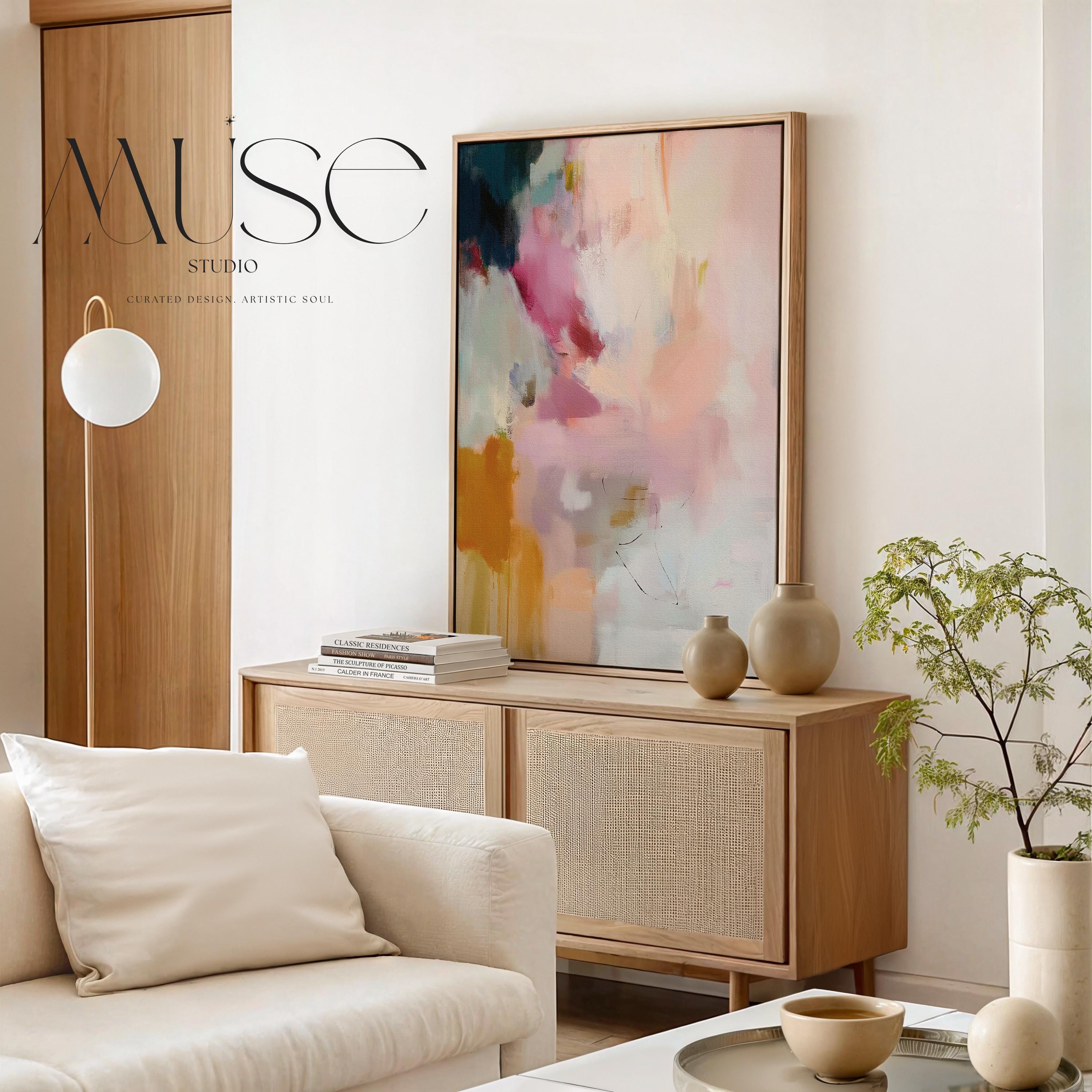 Desert Veil No. 1019 by Muse Studio & Co. vertical abstract wall art in blush coral ochre neutral tones printed with museum-grade giclée inks on premium canvas and framed in a natural wood float frame, styled in a warm modern living room.