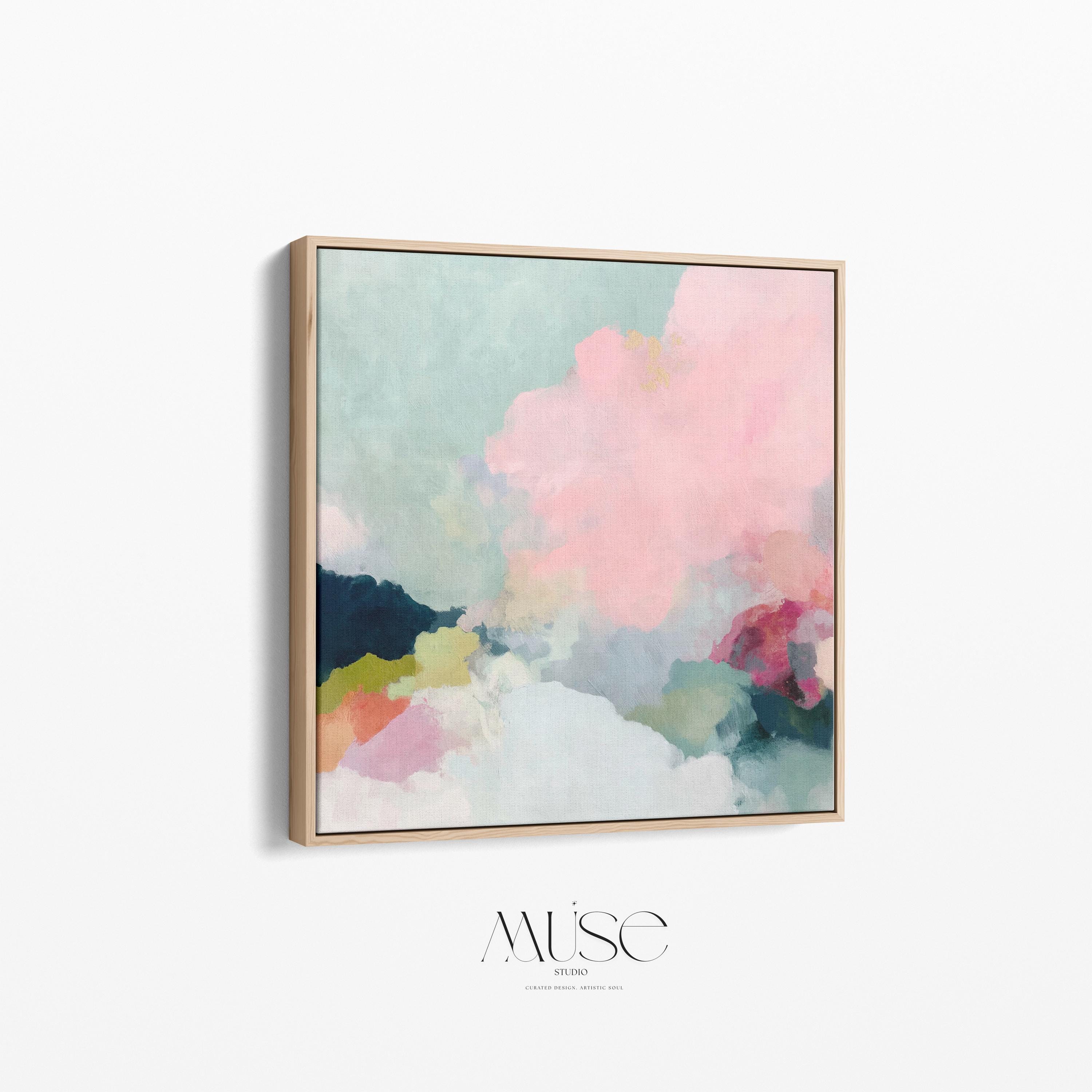 Square framed pastel abstract wall art by Muse Studio featuring blush pink cloud-like forms with soft green and cream tones. Printed with museum-grade giclée inks on premium artist canvas and finished in custom wood float frames in natural, white, black, or antique gold and silver, designed for bedrooms or serene living spaces.