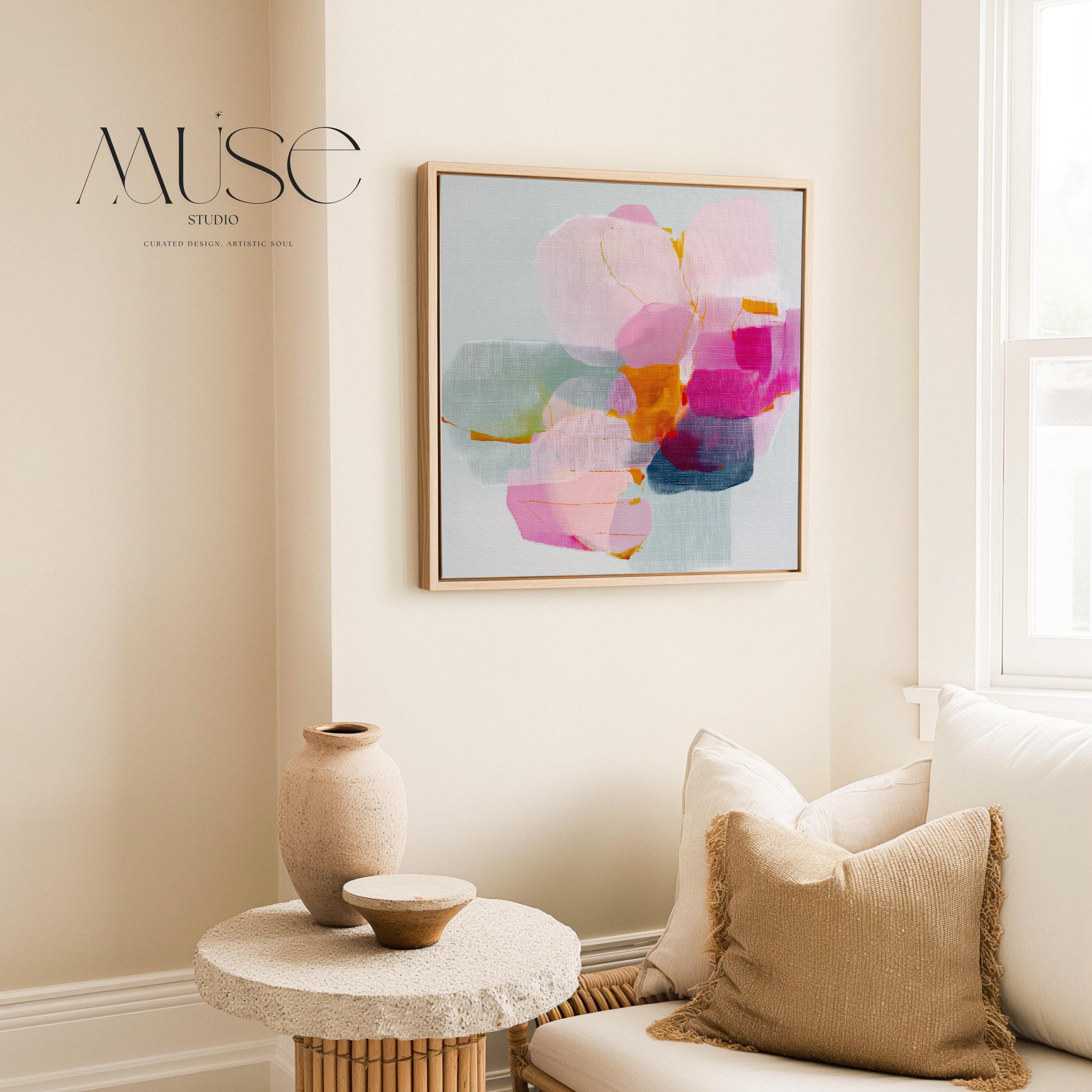 First Bloom 1052 by Muse Studio large framed floral wall art featuring blush pink, magenta, soft blue, and golden ochre painterly blooms printed with museum-grade giclée inks on premium gallery-wrapped canvas, framed in natural wood for Romantic Botanical bedrooms and serene designer interiors.