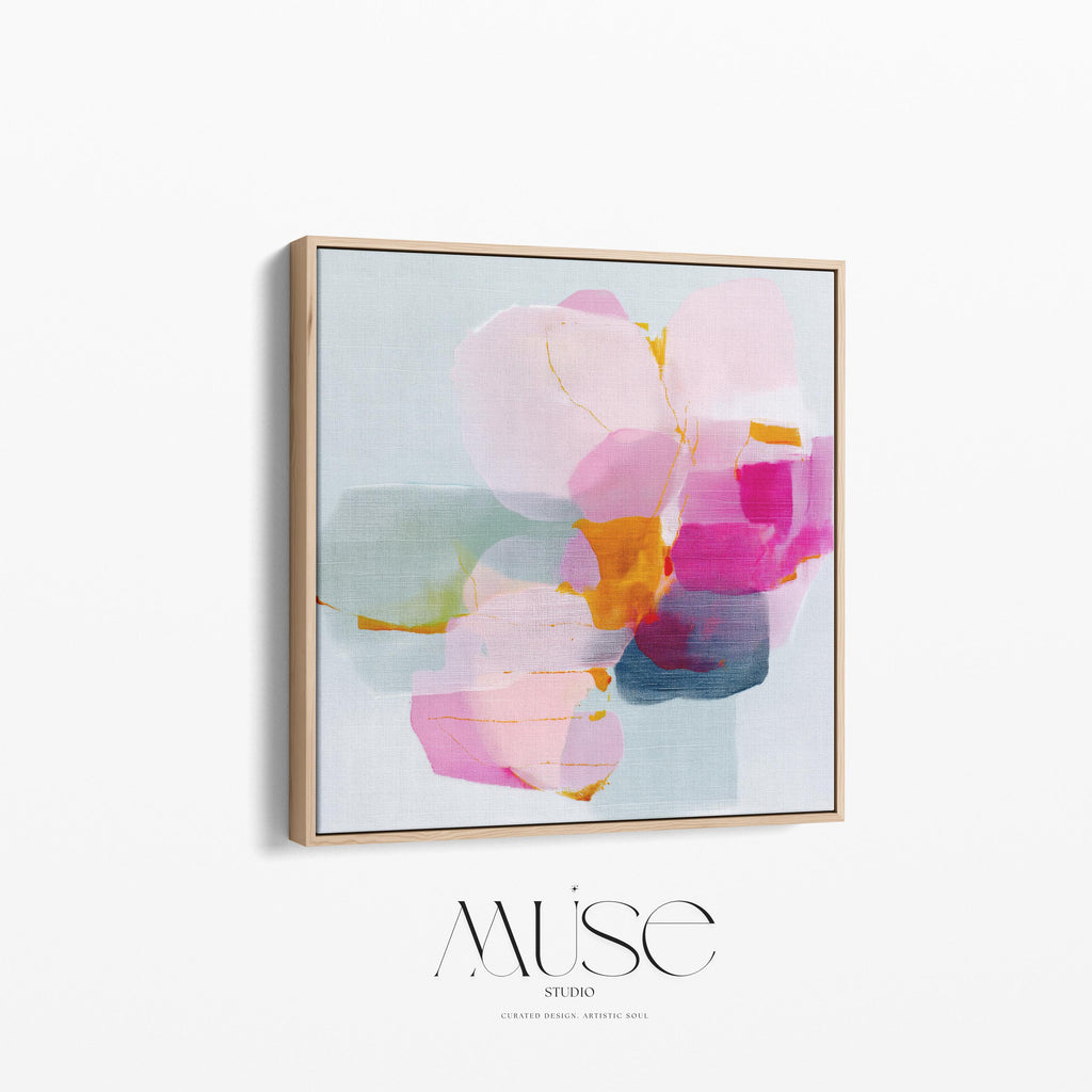 First Bloom 1052 by Muse Studio large framed floral wall art featuring blush pink, magenta, soft blue, and golden ochre painterly blooms printed with museum-grade giclée inks on premium gallery-wrapped canvas, framed in natural wood for Romantic Botanical bedrooms and serene designer interiors.