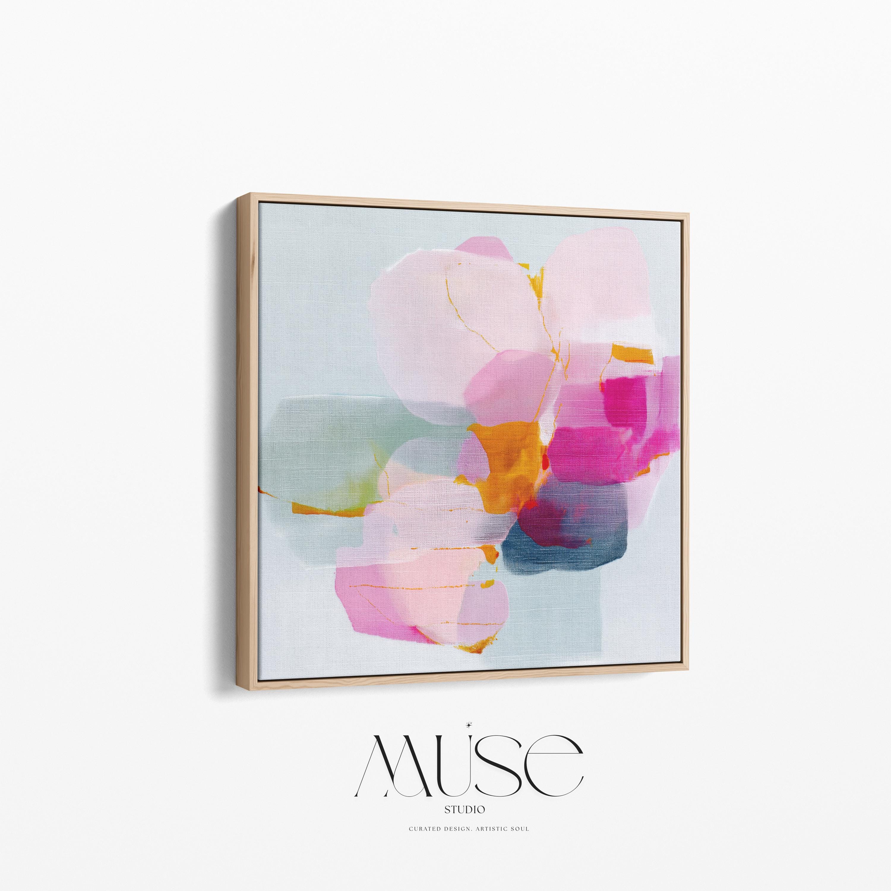 First Bloom 1052 by Muse Studio large framed floral wall art featuring blush pink, magenta, soft blue, and golden ochre painterly blooms printed with museum-grade giclée inks on premium gallery-wrapped canvas, framed in natural wood for Romantic Botanical bedrooms and serene designer interiors.
