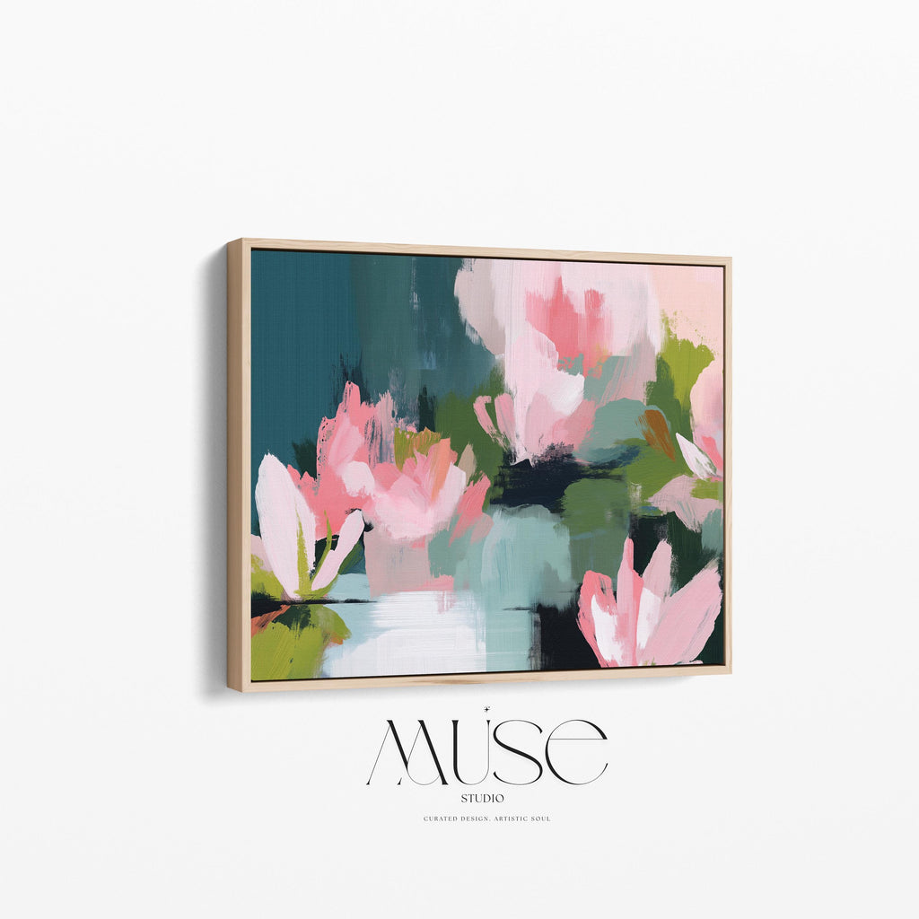 Magnolia Reverie No. 1037 by Muse Studio & Co. blush pink magnolia floral wall art with sage green and deep teal botanical brushwork printed with museum-grade giclée inks on premium gallery-wrapped cotton canvas and custom framed in natural wood with optional white, black, antique gold, or antique silver float frames to complement any decor style, styled in a coastal tropical beach home living room with airy interiors and light wood floors.