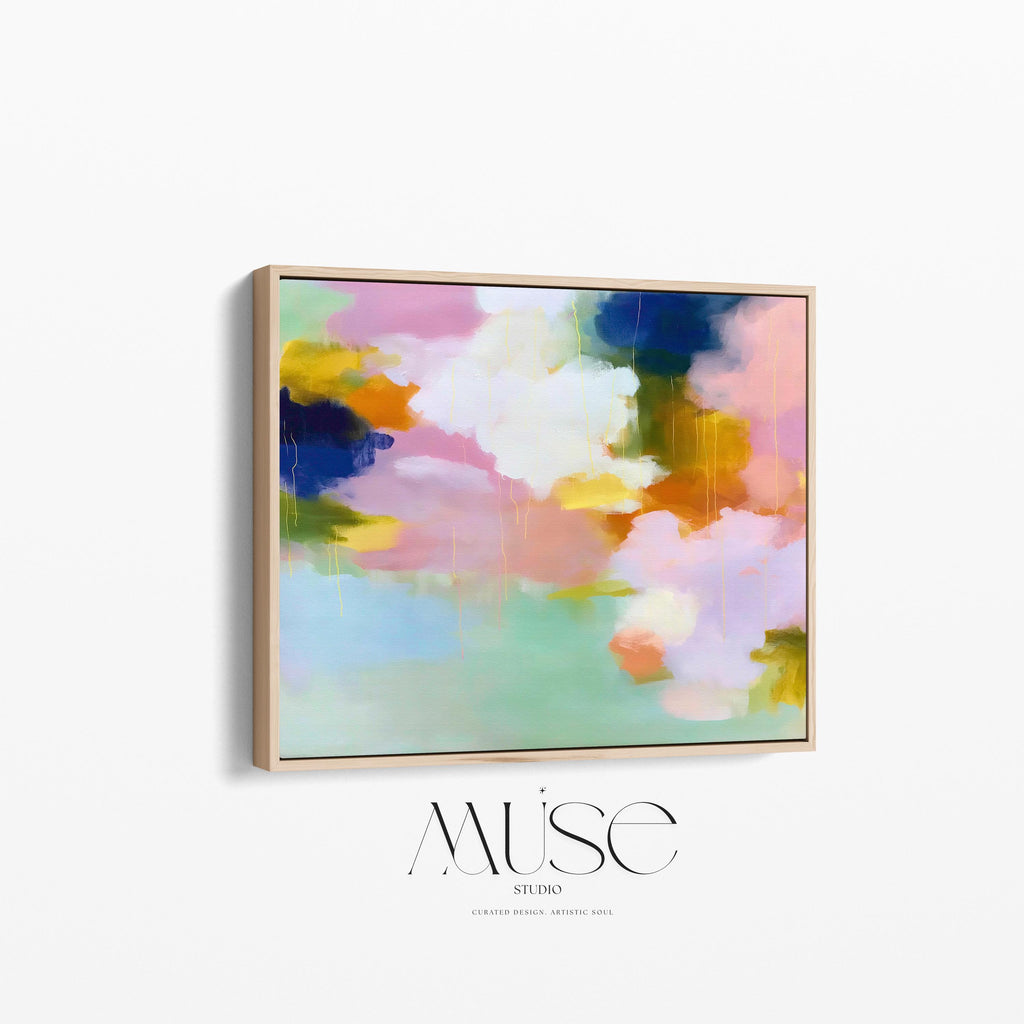 Blush Crescendo No. 291 by Muse Studio & Co. large horizontal pastel abstract framed canvas wall art in blush pink, teal and cream tones printed with museum-grade giclée inks on premium gallery-wrapped artist canvas with custom float frame options in natural, white, black, antique gold or antique silver, styled above a sofa in a soft contemporary living room.