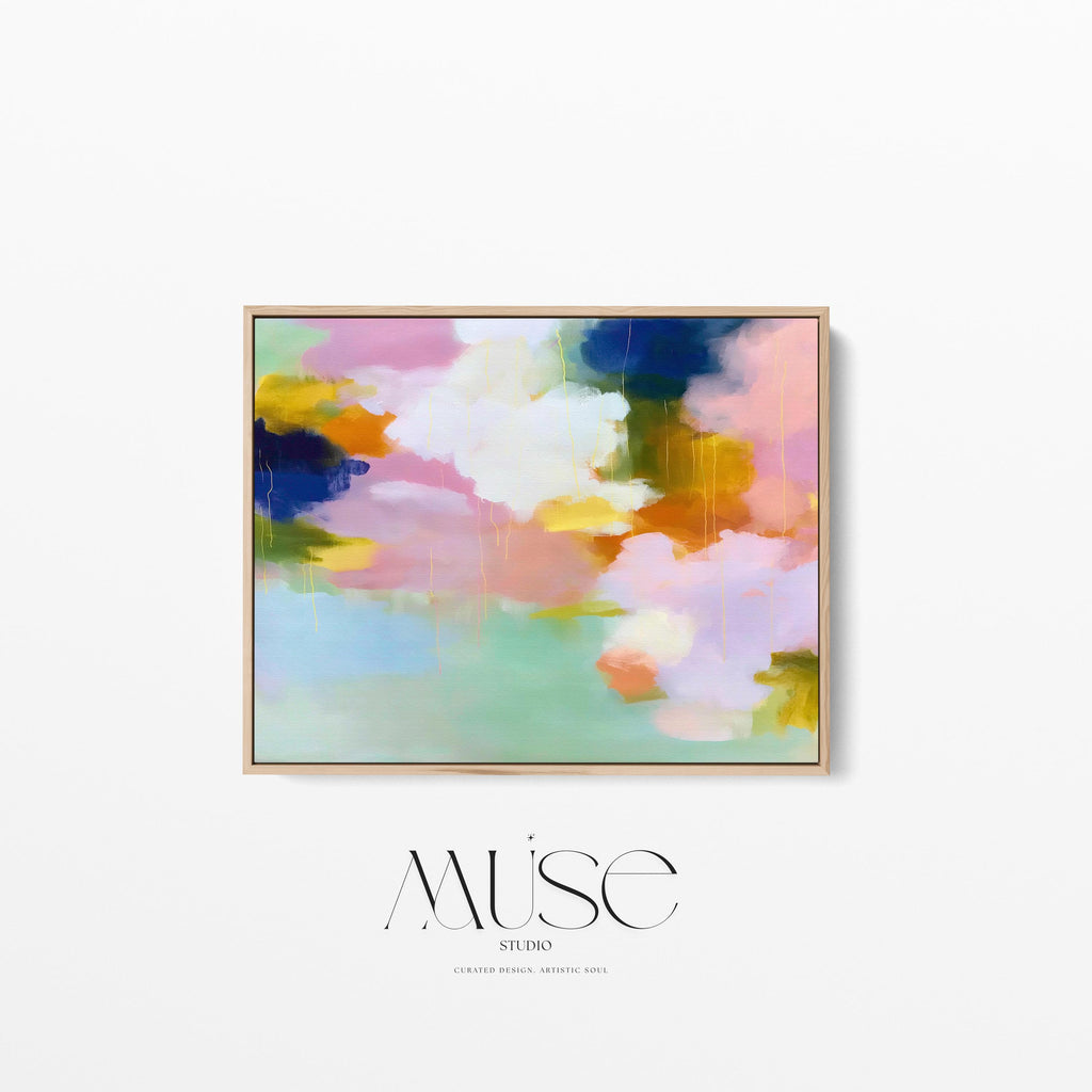 Blush Crescendo No. 291 by Muse Studio & Co. large horizontal pastel abstract framed canvas wall art in blush pink, teal and cream tones printed with museum-grade giclée inks on premium gallery-wrapped artist canvas with custom float frame options in natural, white, black, antique gold or antique silver, styled above a sofa in a soft contemporary living room.