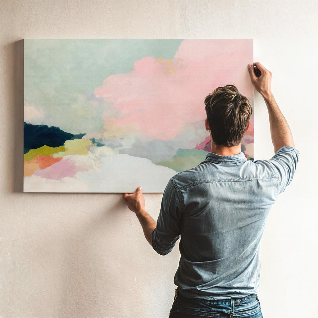 Spring Dawn No. 1059 by Muse Studio & Co. pink clouds abstract canvas wall art featuring blush pink, mint green, navy, coral, and soft butter yellow pastel colors printed with museum-grade giclée inks on premium gallery-wrapped artist canvas, styled above a neutral sofa in a calm designer living room interior.