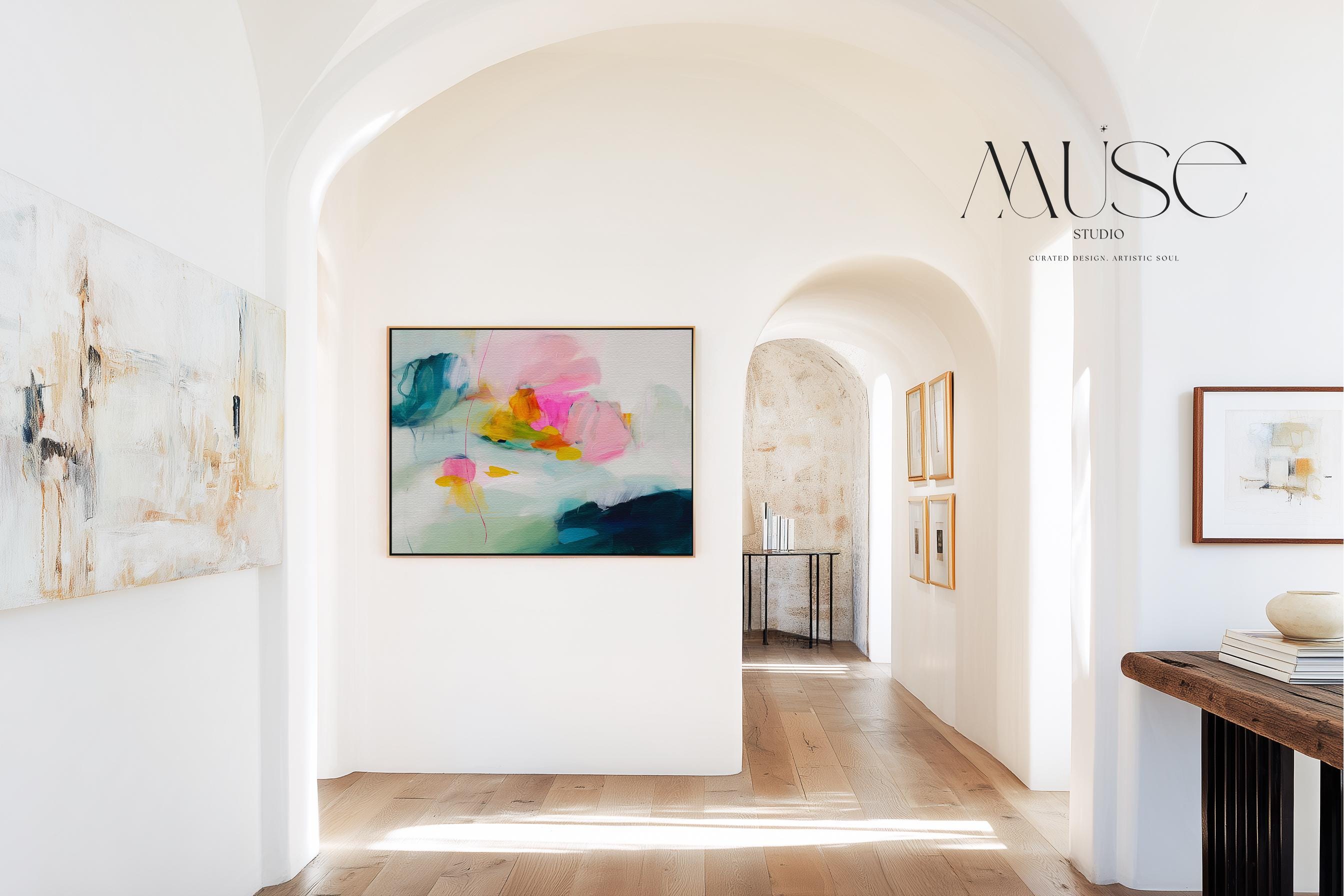 Poppy Fields No. 454 by Muse Studio & Co. horizontal colorful abstract wall art in pink, teal, yellow, and cream printed with museum-grade giclée inks on premium canvas, custom framed in natural, white, black, antique gold or silver float frame, styled in a bright designer living room.