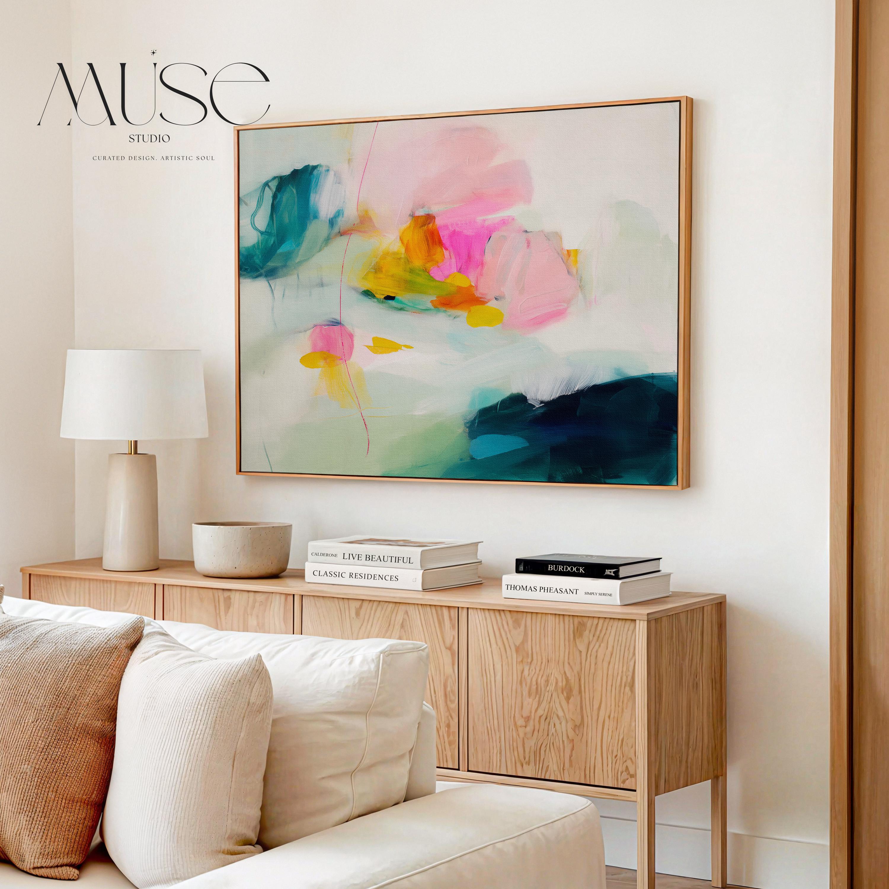 Poppy Fields No. 454 by Muse Studio & Co. horizontal colorful abstract wall art in pink, teal, yellow, and cream printed with museum-grade giclée inks on premium canvas, custom framed in natural, white, black, antique gold or silver float frame, styled in a bright designer living room.