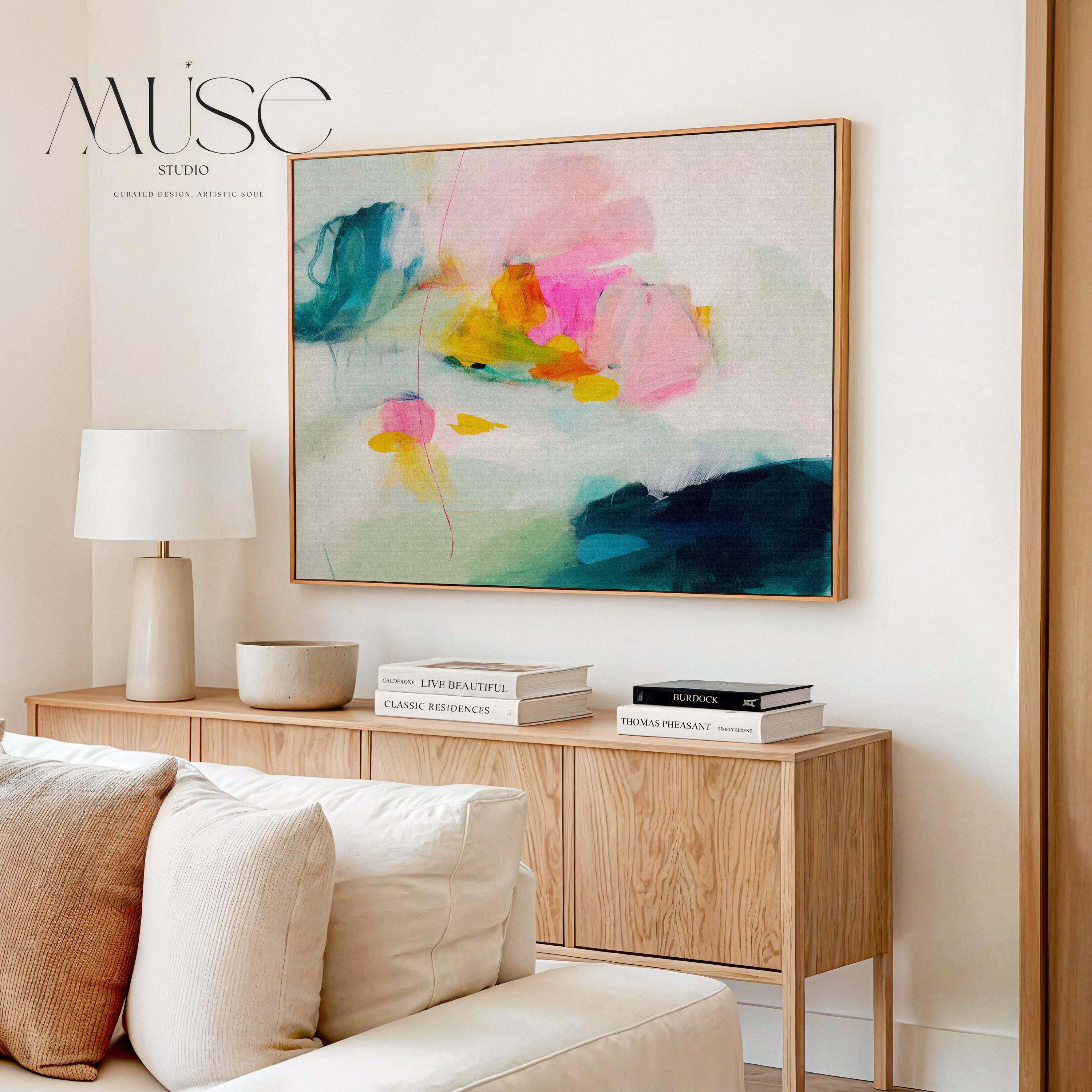 Poppy Fields No. 454 by Muse Studio & Co. horizontal colorful abstract wall art in pink, teal, yellow, and cream printed with museum-grade giclée inks on premium canvas, custom framed in natural, white, black, antique gold or silver float frame, styled in a bright designer living room.