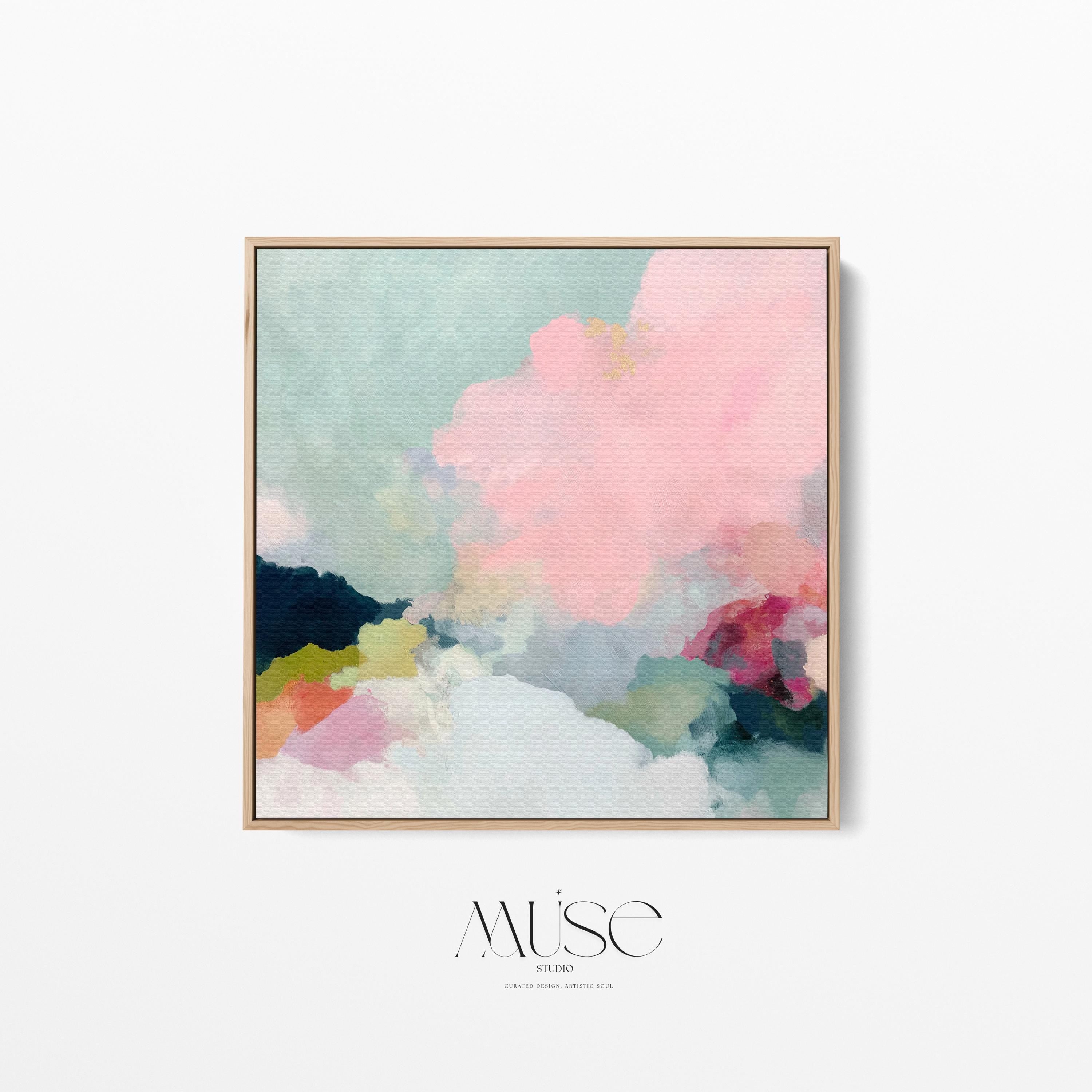 Square framed pastel abstract wall art by Muse Studio featuring blush pink cloud-like forms with soft green and cream tones. Printed with museum-grade giclée inks on premium artist canvas and finished in custom wood float frames in natural, white, black, or antique gold and silver, designed for bedrooms or serene living spaces.