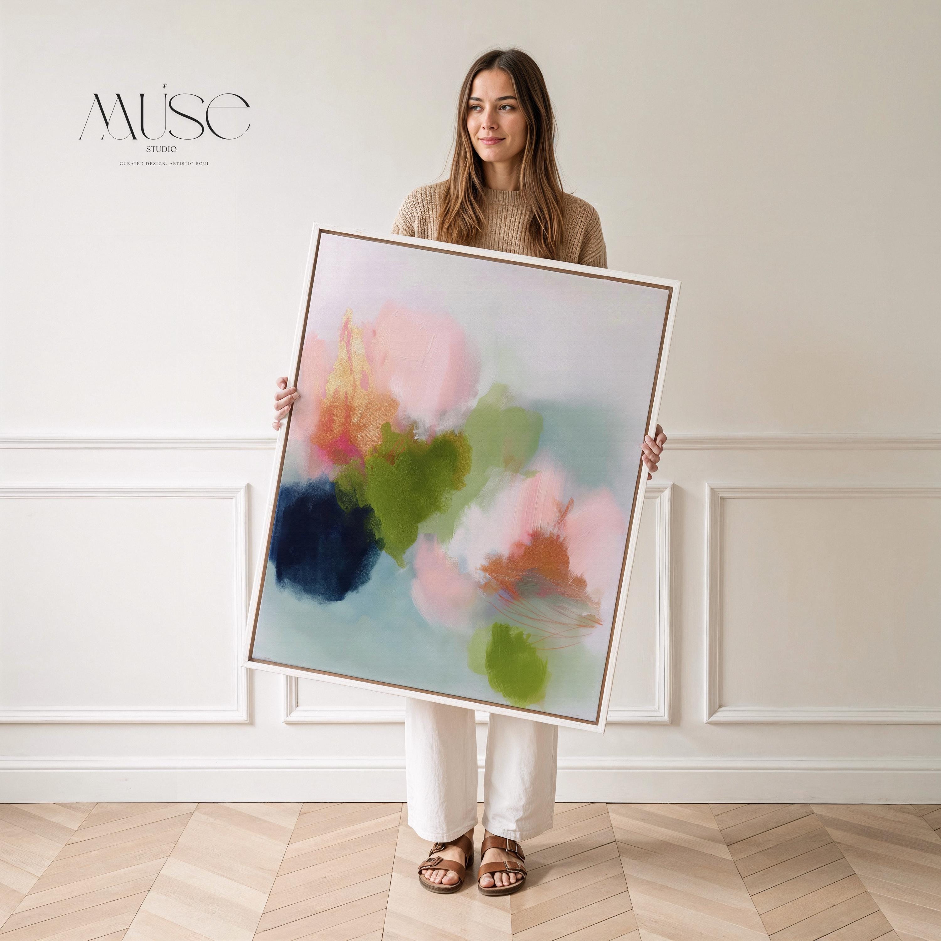 Muse Studio framed wall art in blush pink, olive green, soft aqua, and peach floral abstract tones, printed with museum-grade giclée inks on premium artist canvas and available in custom natural, white, black, antique gold, or antique silver float frames, styled as vertical statement artwork for a bedroom, office, or living room.