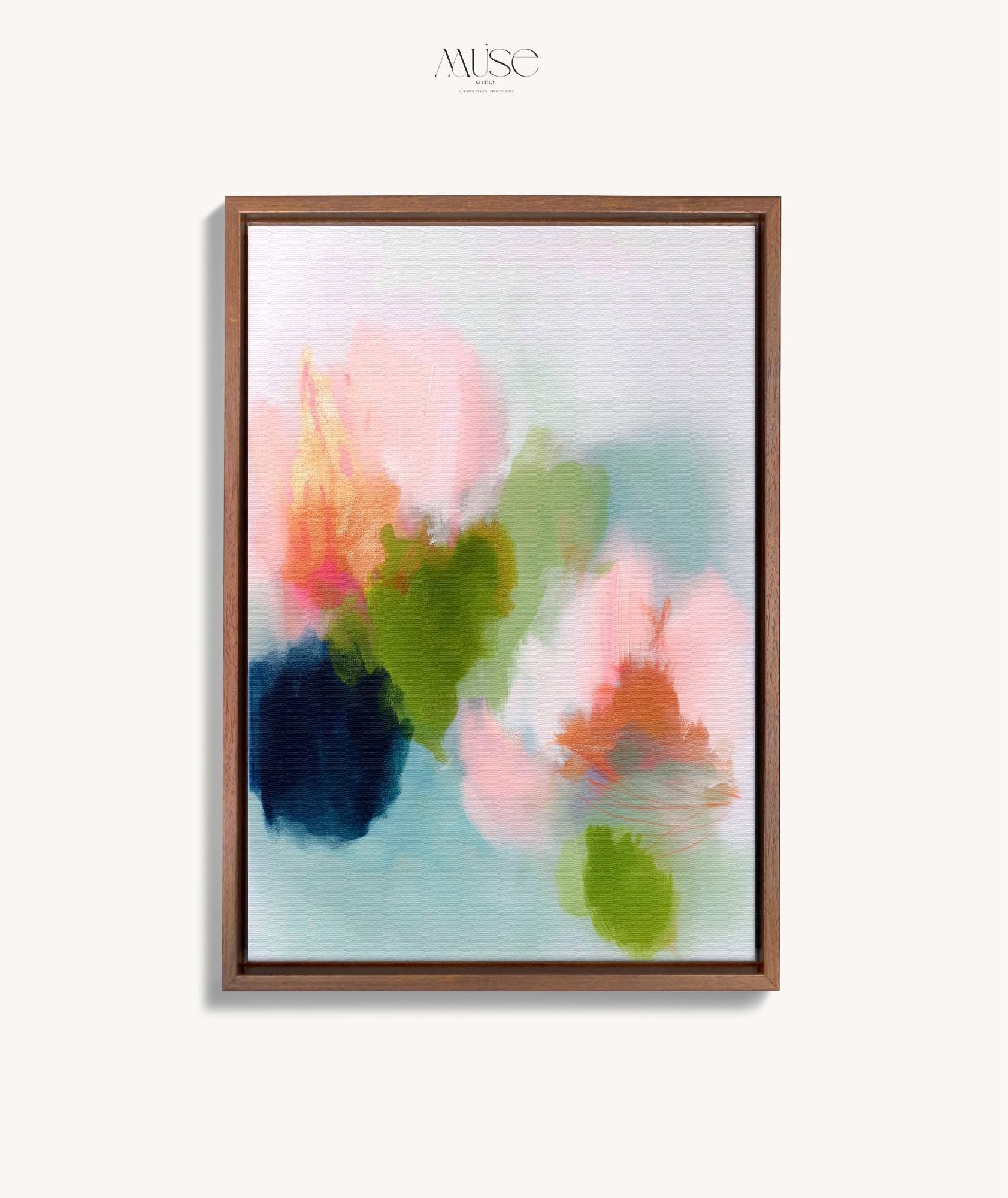 Muse Studio framed wall art in blush pink, olive green, soft aqua, and peach floral abstract tones, printed with museum-grade giclée inks on premium artist canvas and available in custom natural, white, black, antique gold, or antique silver float frames, styled as vertical statement artwork for a bedroom, office, or living room.
