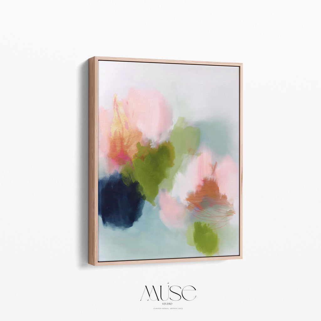 Muse Studio framed wall art in blush pink, olive green, soft aqua, and peach floral abstract tones, printed with museum-grade giclée inks on premium artist canvas and available in custom natural, white, black, antique gold, or antique silver float frames, styled as vertical statement artwork for a bedroom, office, or living room.