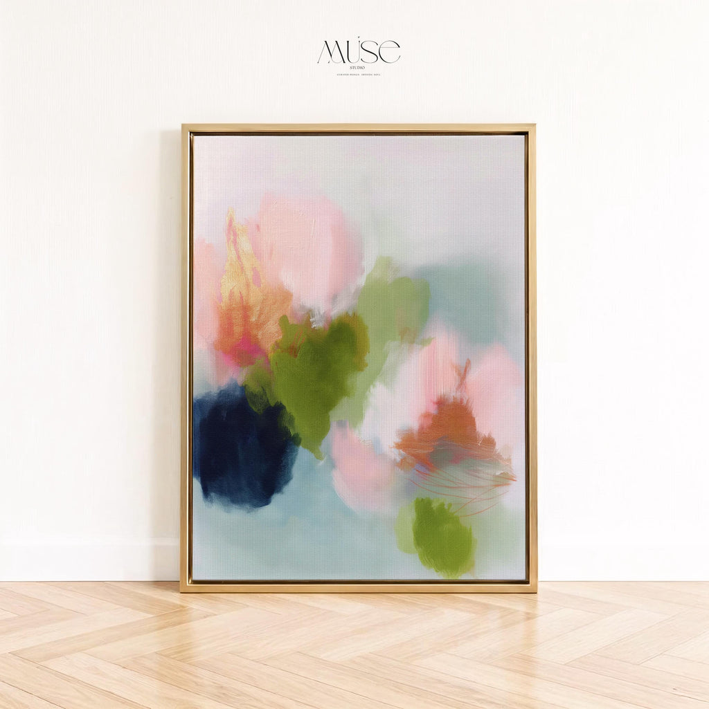 Muse Studio framed wall art in blush pink, olive green, soft aqua, and peach floral abstract tones, printed with museum-grade giclée inks on premium artist canvas and available in custom natural, white, black, antique gold, or antique silver float frames, styled as vertical statement artwork for a bedroom, office, or living room.