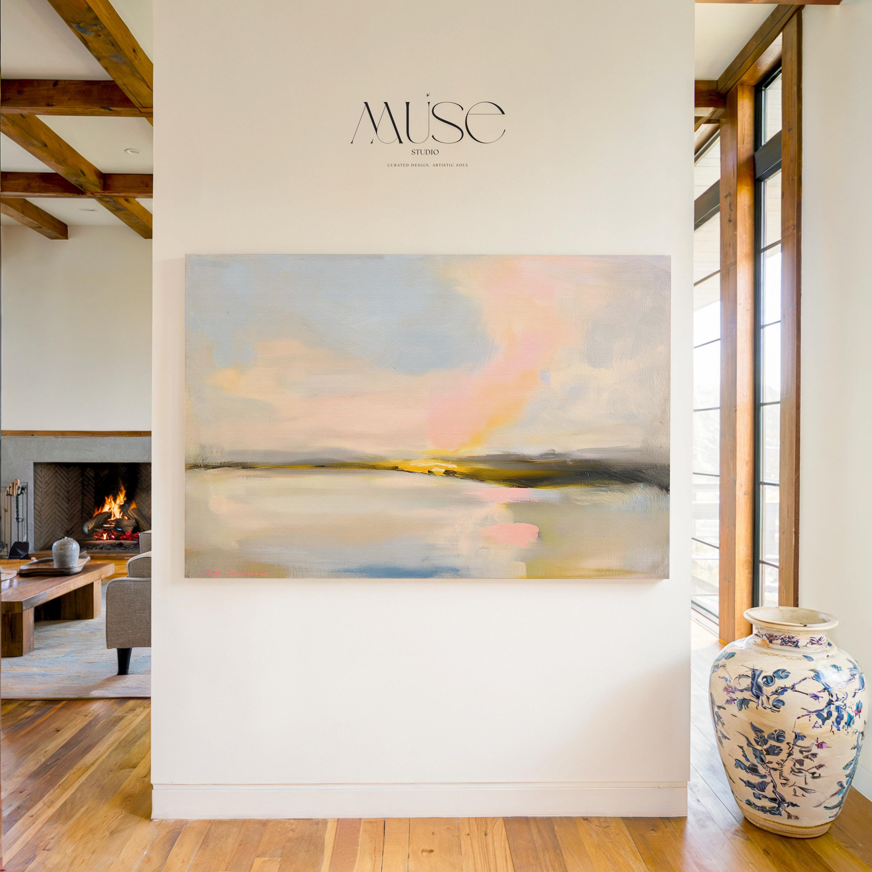 Muse Studio pastel coastal canvas wall art featuring a soft pink and blue abstract landscape with cream, gray, blush, and golden neutral tones. Large square canvas artwork with painterly horizon movement, museum-grade giclée inks, and premium gallery-wrapped cotton canvas, styled above a console for living room, bedroom, office, dining room, or modern coastal interiors.