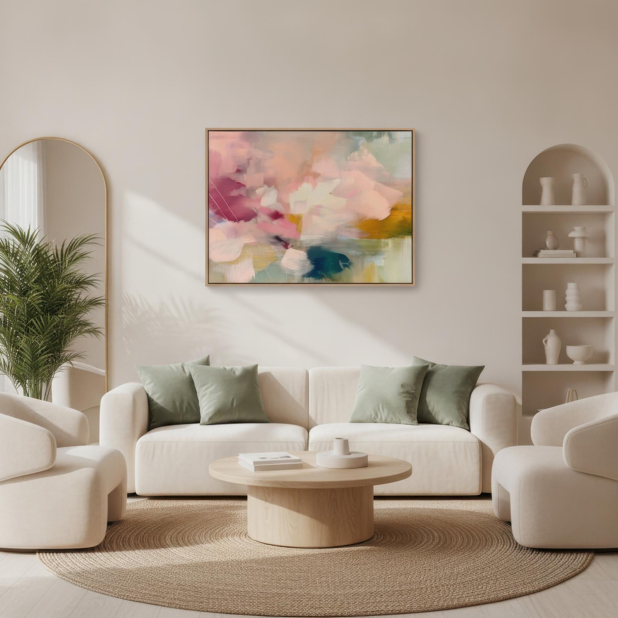 Soft blush, coral, teal and cream floral abstract framed canvas wall art by Muse Studio & Co. in a natural wood floating frame, styled as a calming focal piece in a warm contemporary living space.